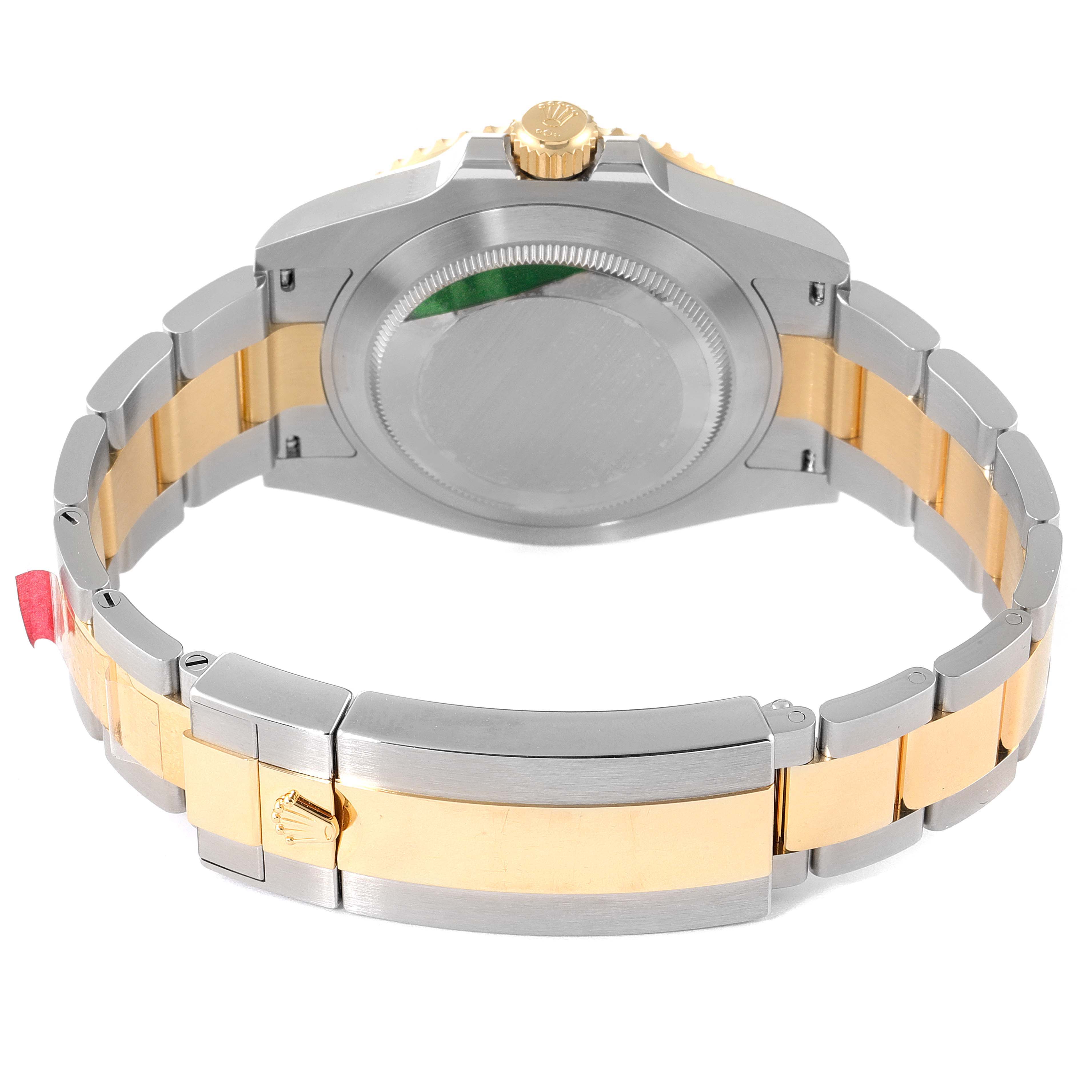 The image shows the back view of a Rolex Submariner 126613 Men's Steel and Gold (two tone) Black Dial 126613 Men's Steel and Gold (two tone) Black Dial watch, highlighting its case back and two-tone bracelet.