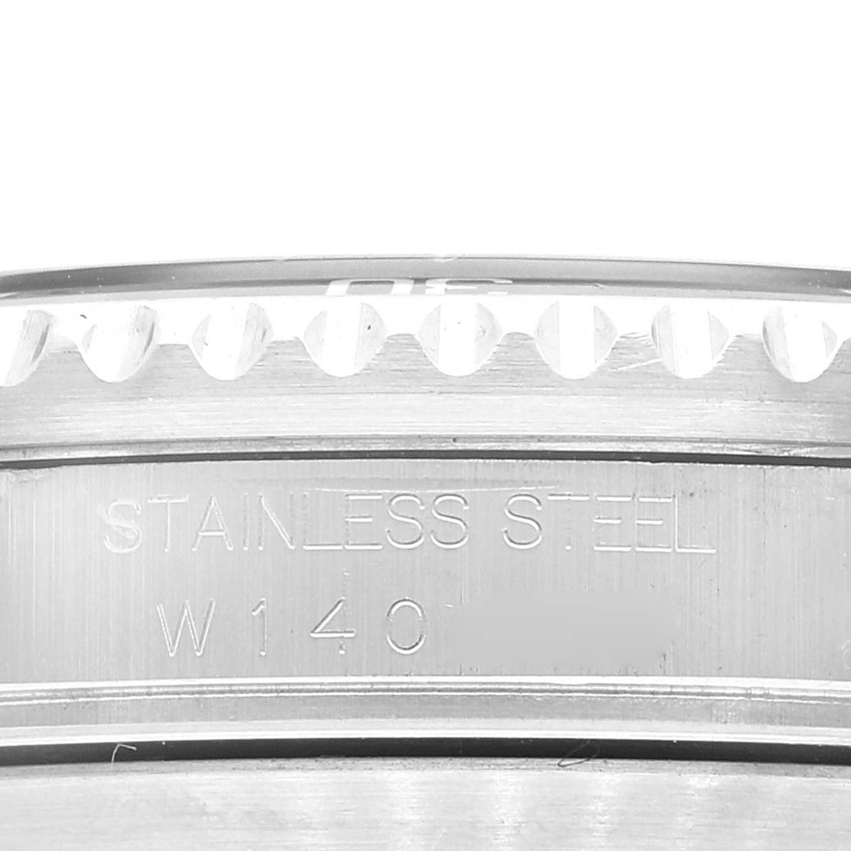 This image shows a close-up of the bezel and inner case body of a Rolex Submariner 16610 Men
s Stainless Steel Black Dial 16610 Men
s Stainless Steel Black Dial watch with the "Stainless Steel" inscription.