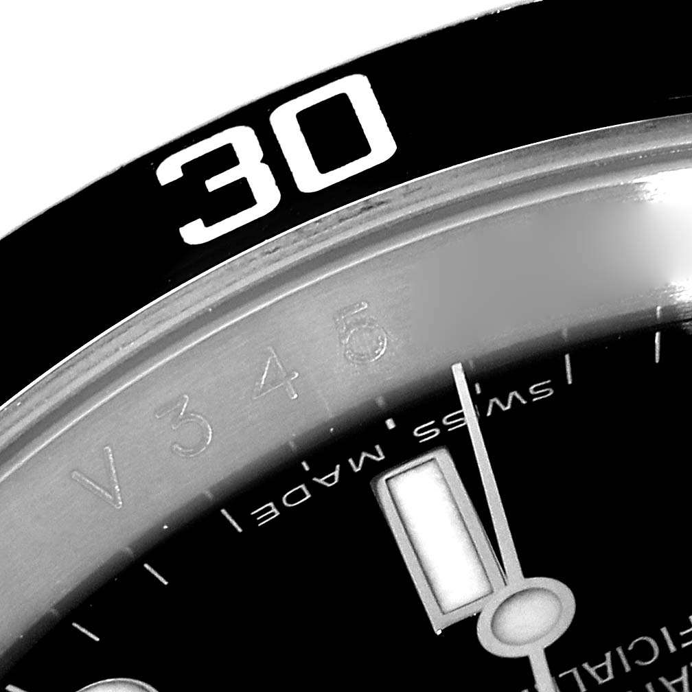This image shows a close-up partial view of the bezel and dial of a Rolex Submariner 16610 Men
s Stainless Steel Black Dial 16610 Men
s Stainless Steel Black Dial watch, focusing on the "30" marker.