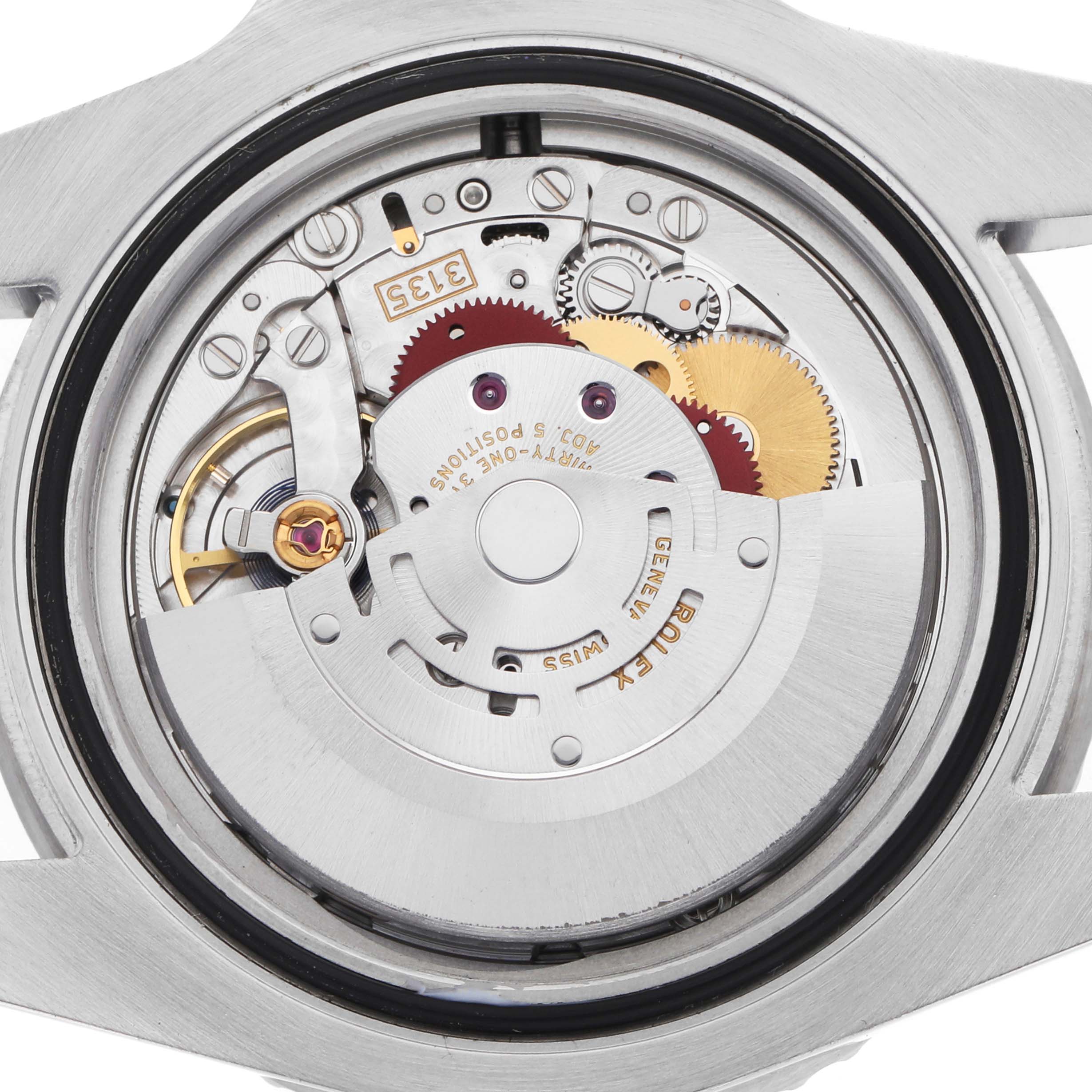 The image shows the movement of a Rolex Submariner 116610LV Men's Stainless Steel Green Dial watch from a top-down angle, revealing its intricate gears and rotor.