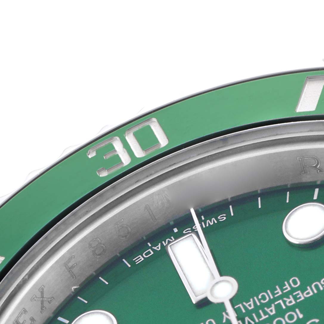 The image shows a detailed close-up of the bezel and part of the dial on a Rolex Submariner 116610LV Men's Stainless Steel Green Dial.