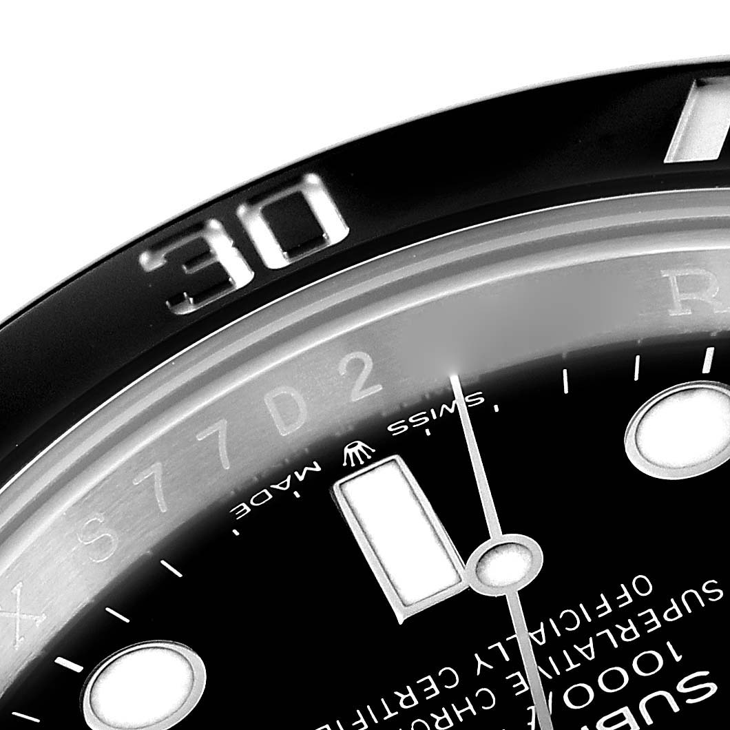 This image shows a close-up angle of the Rolex Submariner 124060 Men
s Stainless Steel Black Dial 124060 Men
s Stainless Steel Black Dial
s bezel, part of the chapter ring, and some dial text.