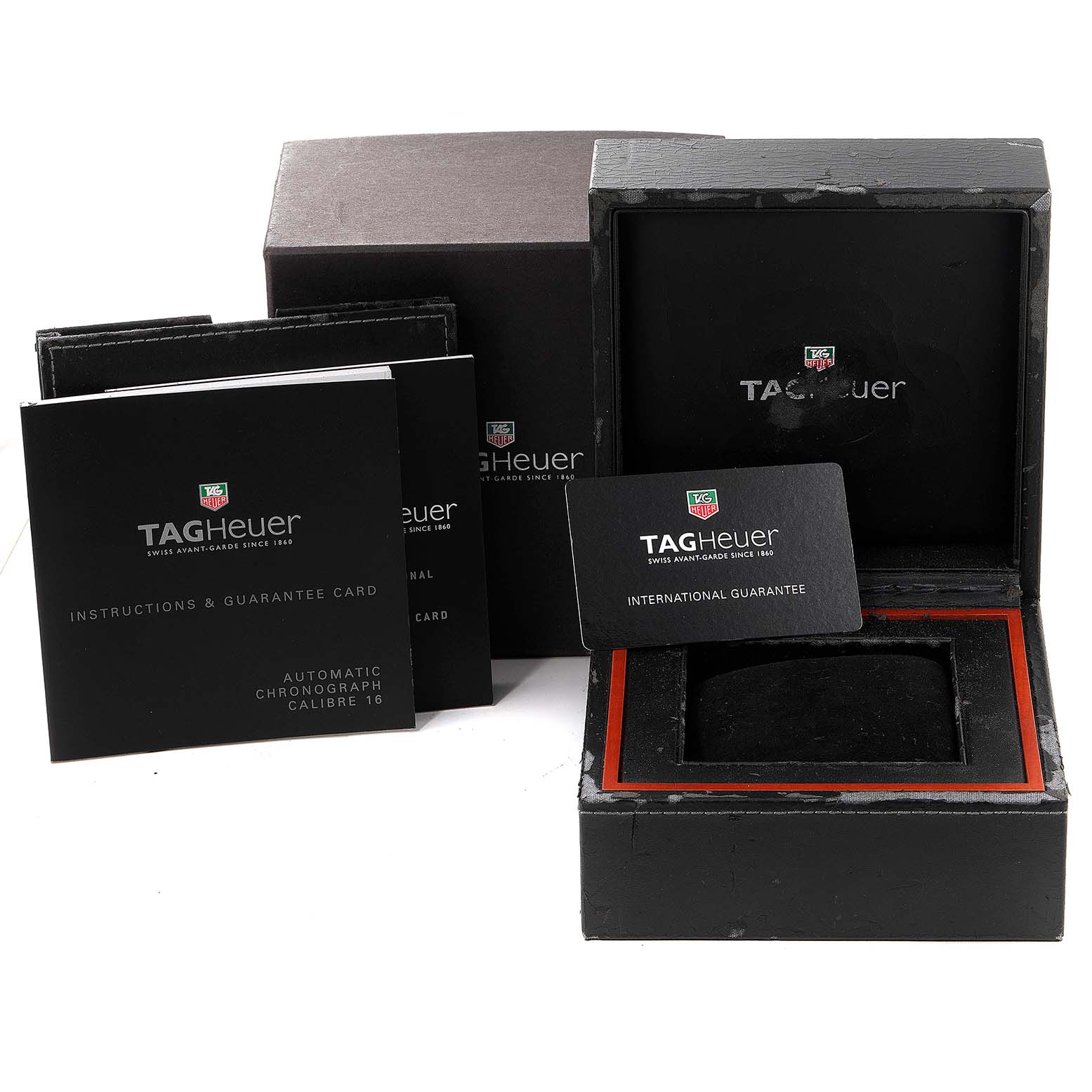 The image shows the Tag Heuer Carrera CV2016 Men's Stainless Steel Black Dial CV2016 Men's Stainless Steel Black Dial watch's box, instruction manual, and guarantee card from a frontal angle.