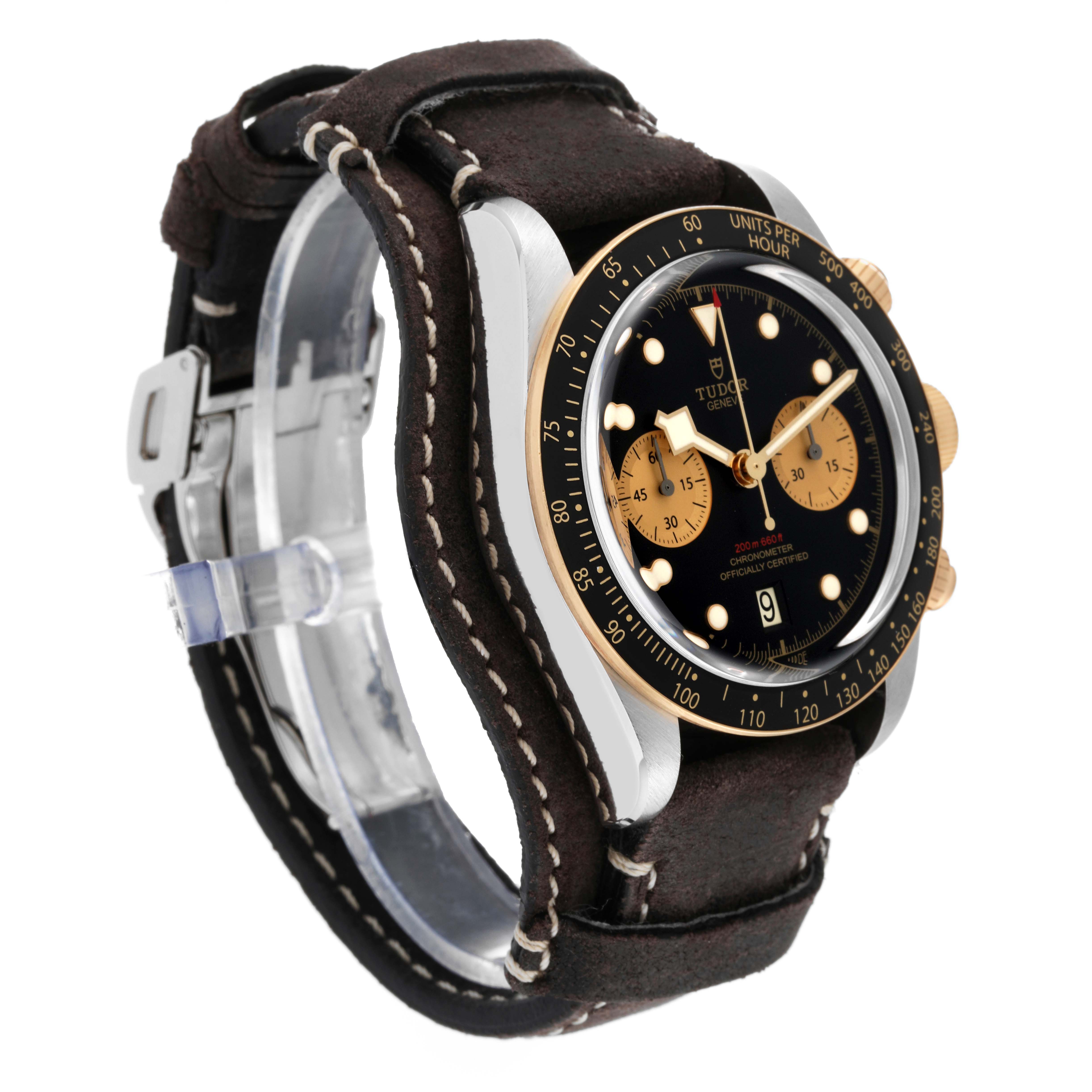 The image shows a Tudor Heritage Black Bay 79363N Men
s Steel and Gold (two tone) Black Dial 79363N Men
s Steel and Gold (two tone) Black Dial watch angled slightly from the side, displaying its face, bezel, and leather strap.