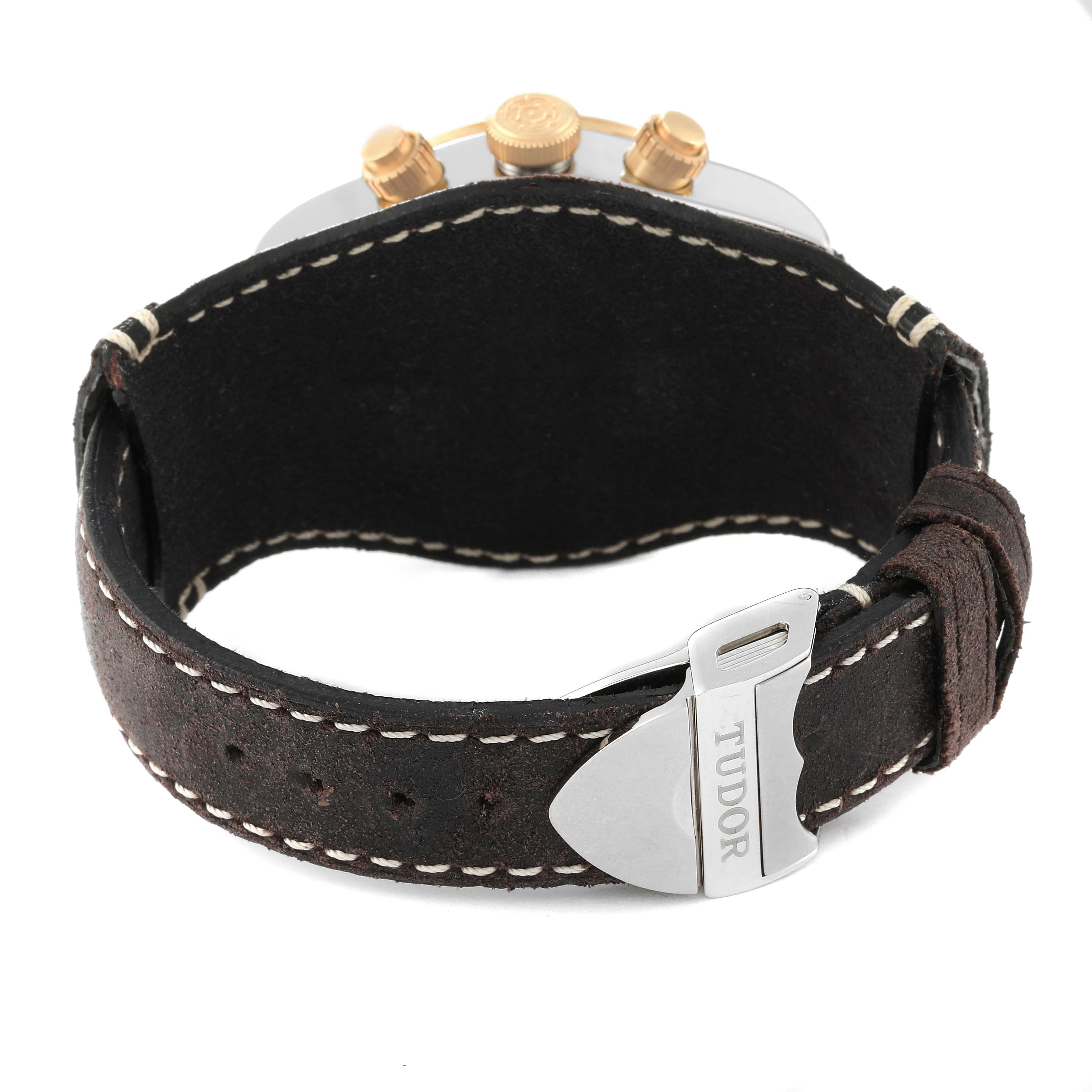 This image shows the back view of the Tudor Heritage Black Bay 79363N Men
s Steel and Gold (two tone) Black Dial 79363N Men
s Steel and Gold (two tone) Black Dial watch, focusing on the leather strap, buckle, and crown.