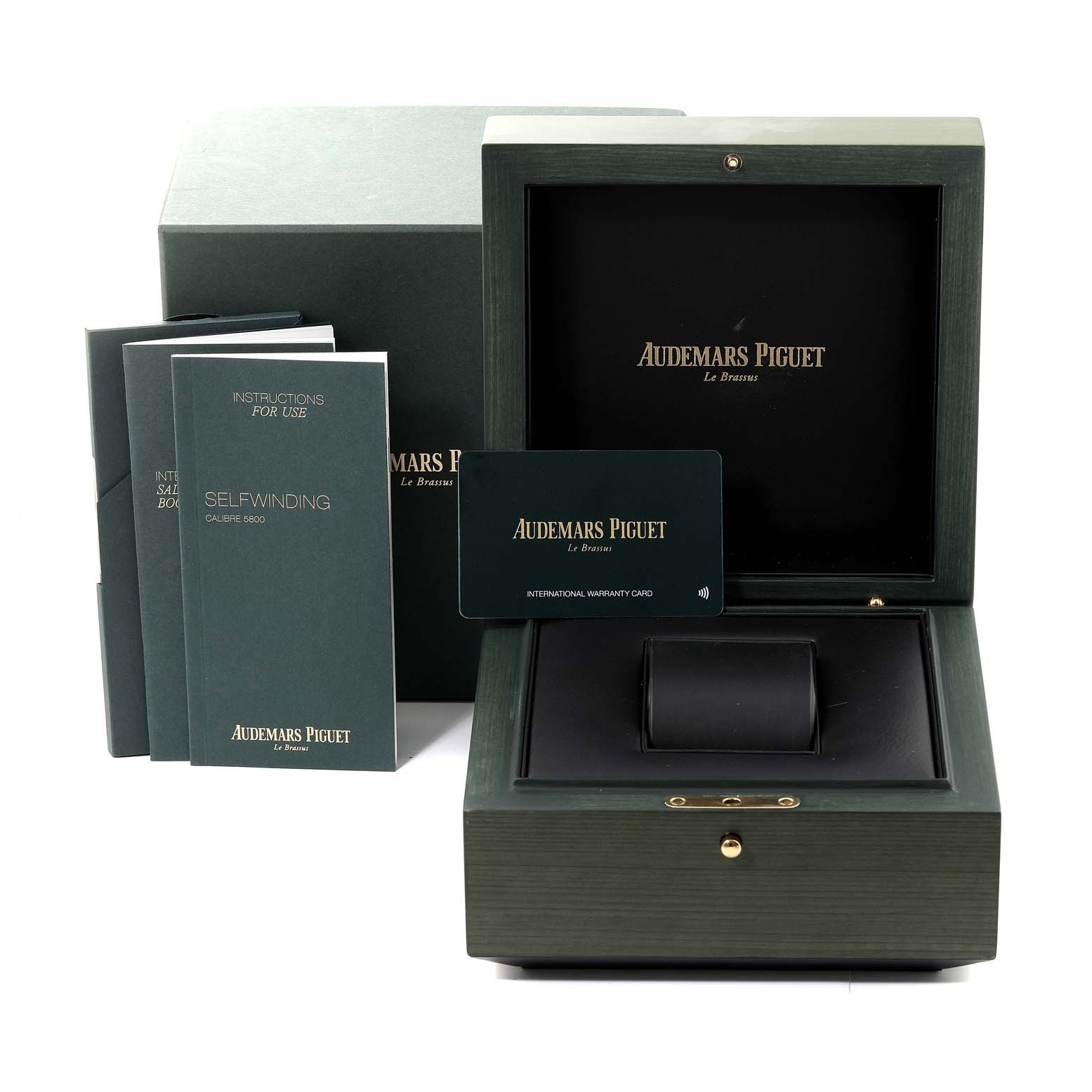 The image shows the packaging and accessories for an Audemars Piguet Royal Oak 77353BC.GG.1263BC.01 Women's White Gold Blue Dial 77353BC.GG.1263BC.01 Women's White Gold Blue Dial, including a box, manuals, and a warranty card.