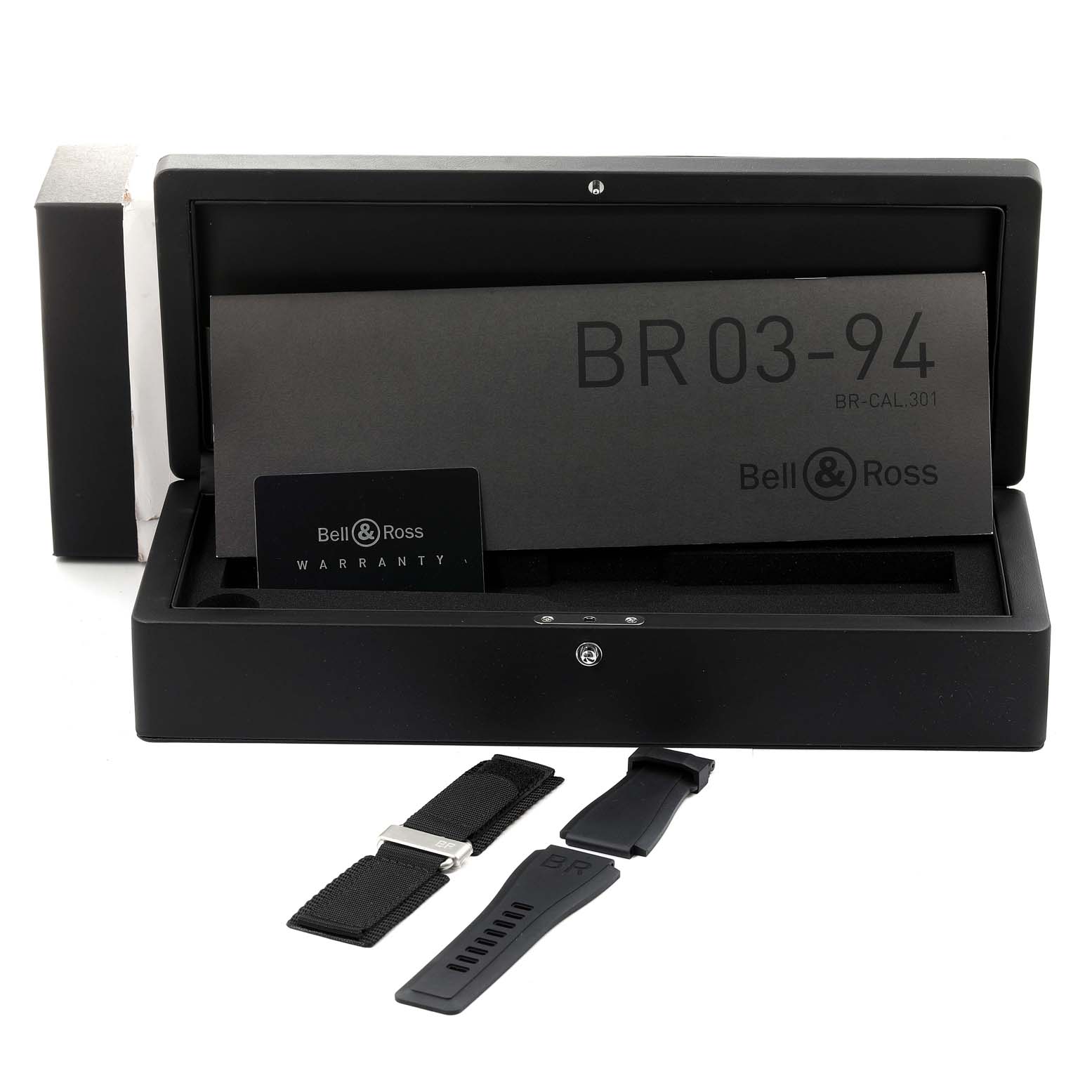 The image shows the open packaging of a Bell & Ross Chronograph BR03-94 with warranty cards and additional straps.
