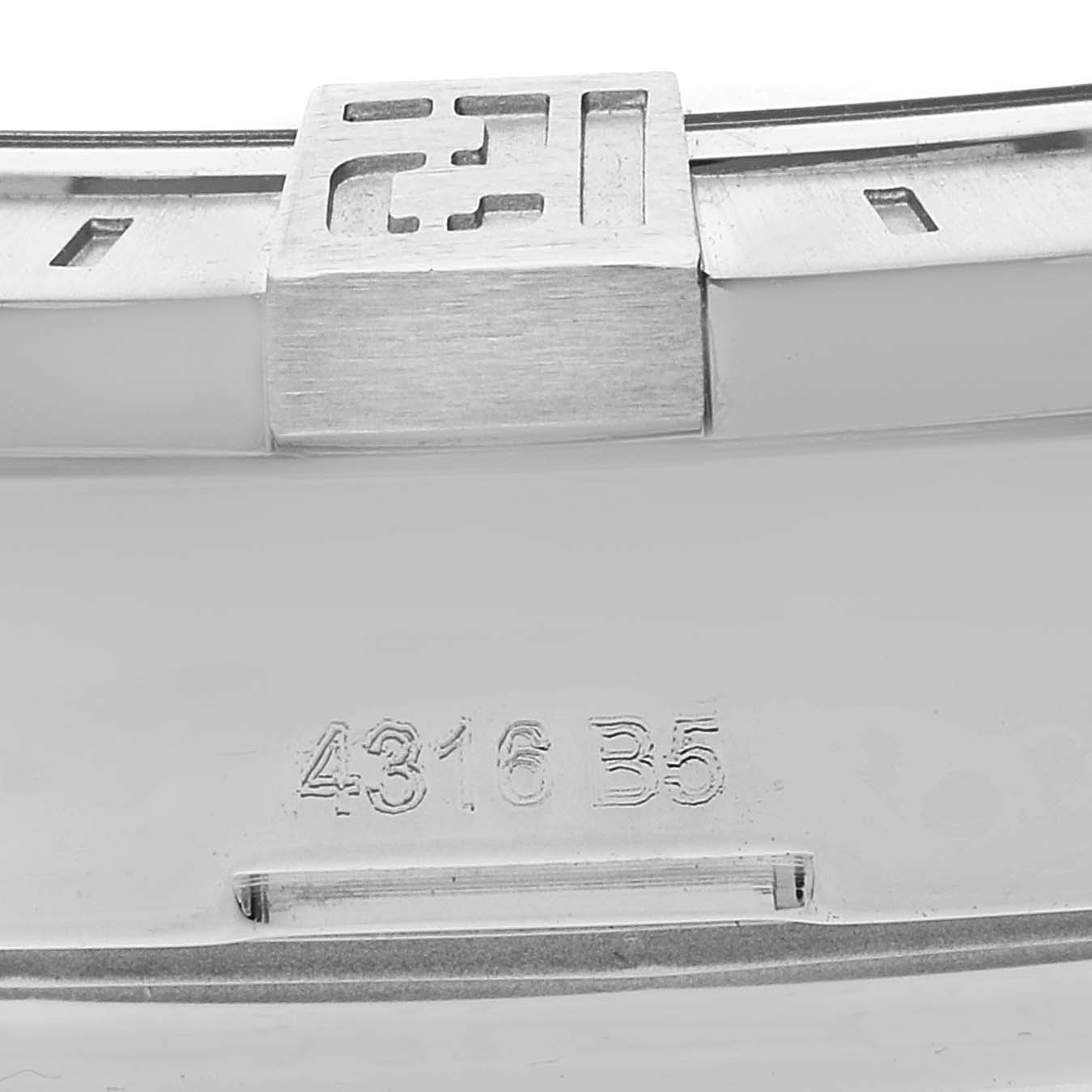 The image shows a close-up of the backside of a Breitling Avenger A32390 Men's Stainless Steel Black Dial A32390 Men's Stainless Steel Black Dial watch clasp, featuring a small portion of the bracelet and an engraved code.