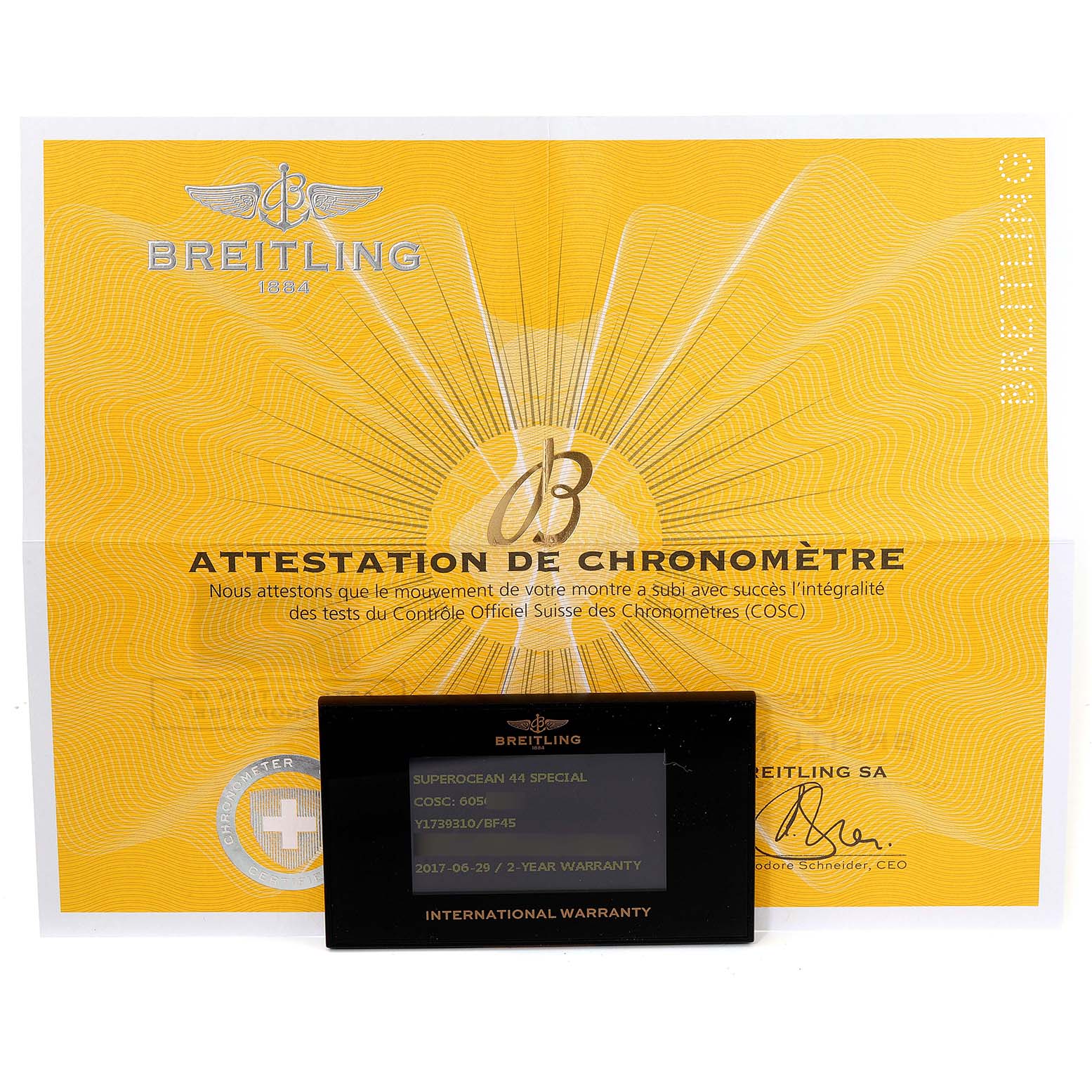 The image shows a Breitling Superocean Y17393 Men's Stainless Steel Black Dial Y17393 Men's Stainless Steel Black Dial model warranty card and COSC certification document from a front angle.
