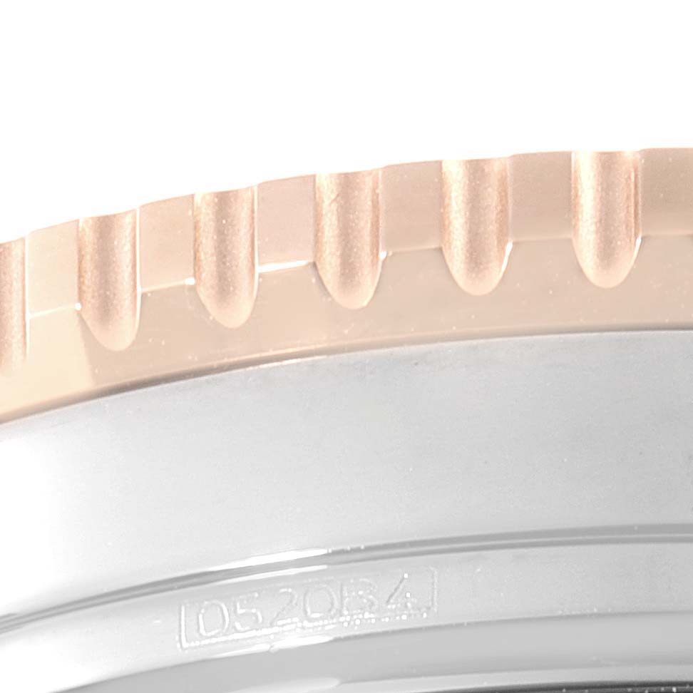 This close-up image of a Breitling Navitimer U13324211B1X1 Men's Steel and Gold (two tone) Black Dial U13324211B1X1 Men's Steel and Gold (two tone) Black Dial watch shows the edge of the bezel with its distinctive notched design.