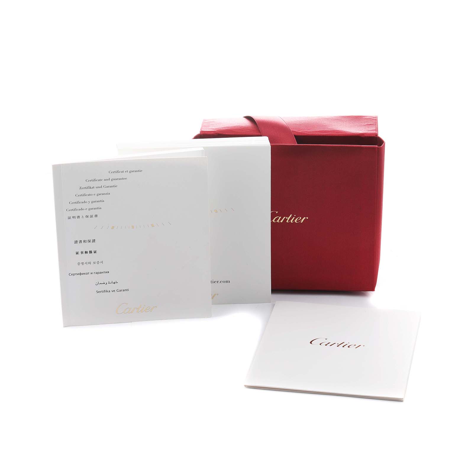 The image shows a red Cartier box and documents, including a warranty booklet for the Ballon Bleu model.