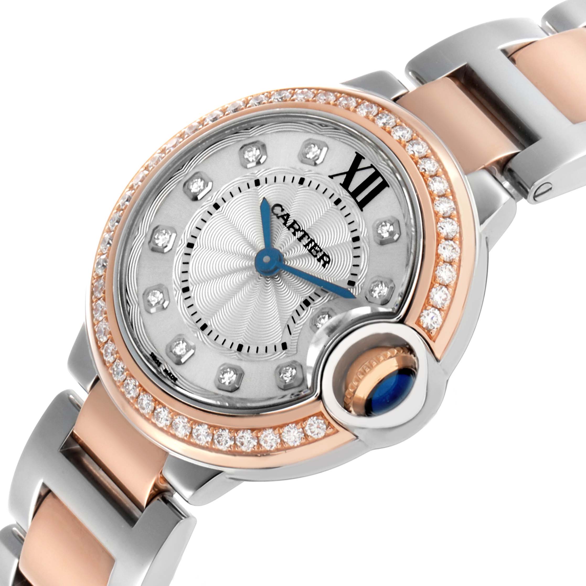 The Cartier Ballon Bleu WE902076 Women's Steel and Gold (two tone) Silver Dial watch is shown at a tilted angle highlighting its diamond bezel, bracelet, and Roman numeral markers.