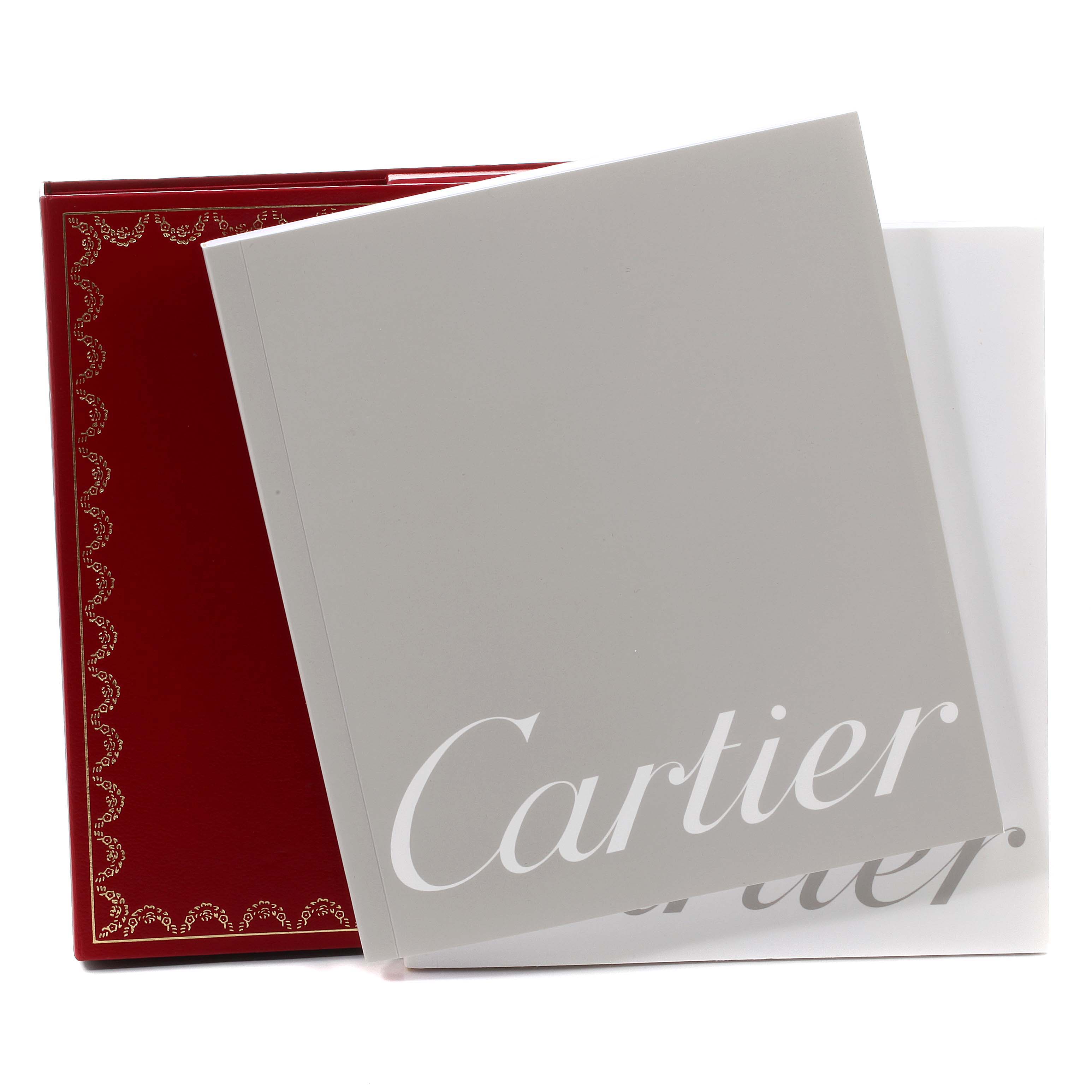 The image shows the packaging and documents for the Cartier Roadster W62025V3 Men's Stainless Steel Silver Dial W62025V3 Men's Stainless Steel Silver Dial, including a red box and a branded booklet.
