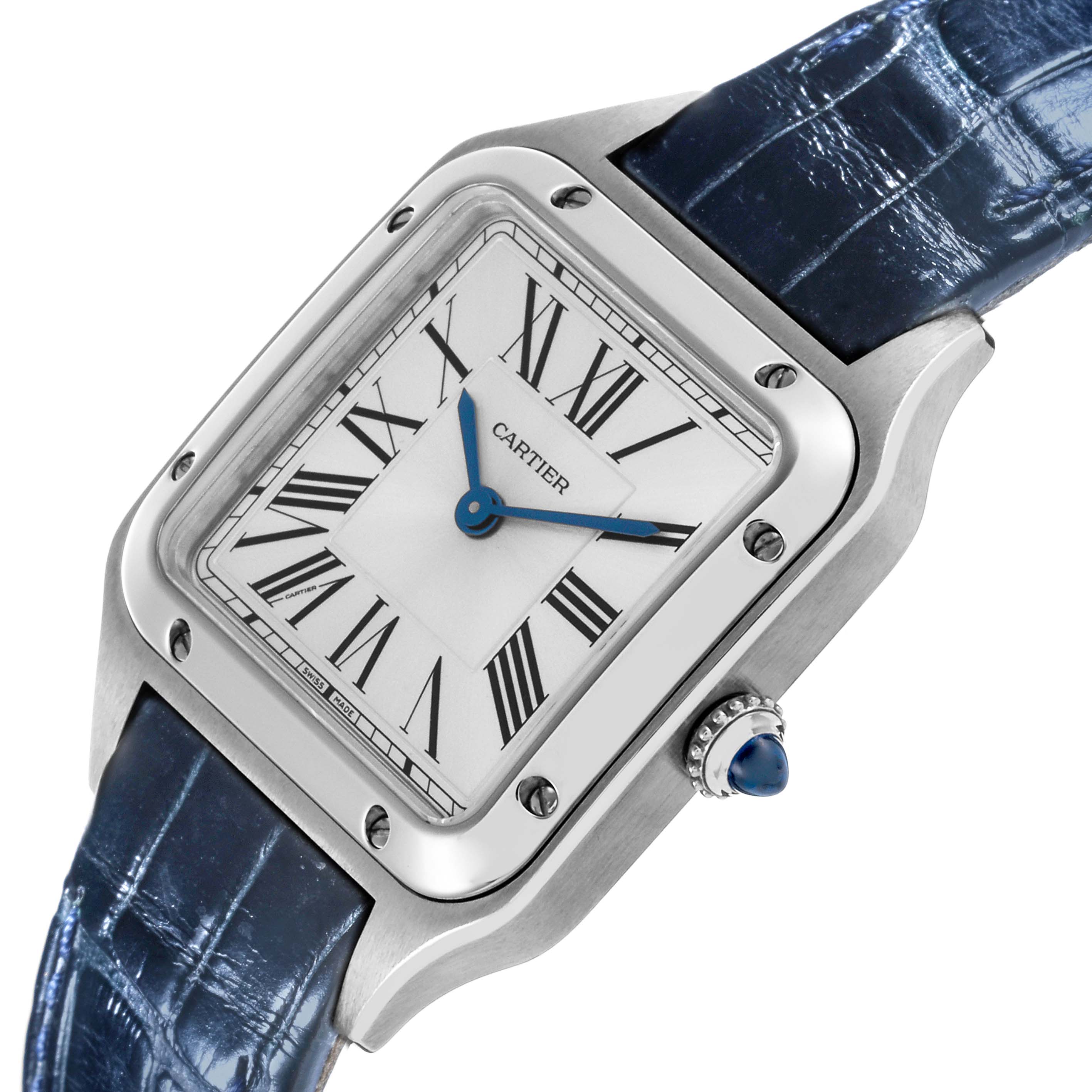 The Cartier Santos WSSA0023 Women's Stainless Steel Silver Dial WSSA0023 Women's Stainless Steel Silver Dial watch is shown at an angled view featuring the face, Roman numerals, case, crown, and a blue strap.
