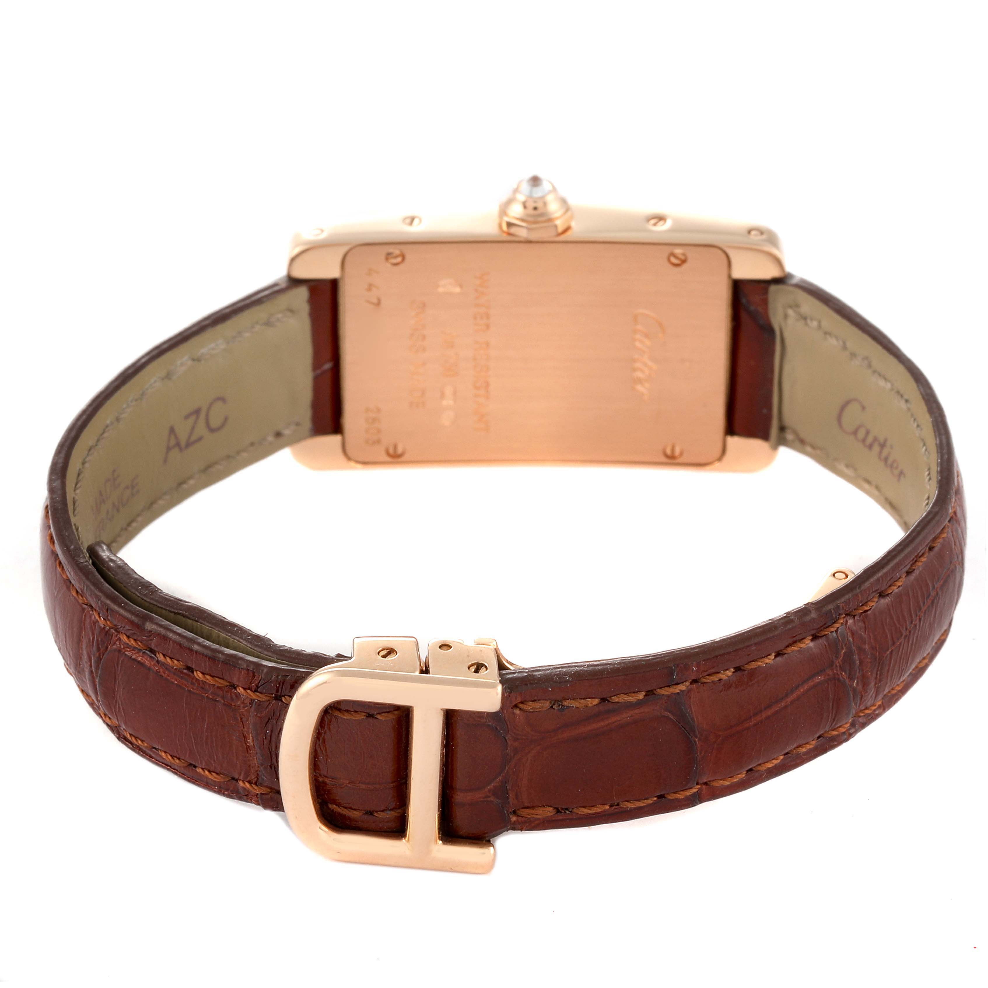 The photo shows the back case, straps, and buckle of a Cartier Tank Americaine WJTA0002 Women
s Rose Gold Silver Dial WJTA0002 Women
s Rose Gold Silver Dial watch from a rear angle.