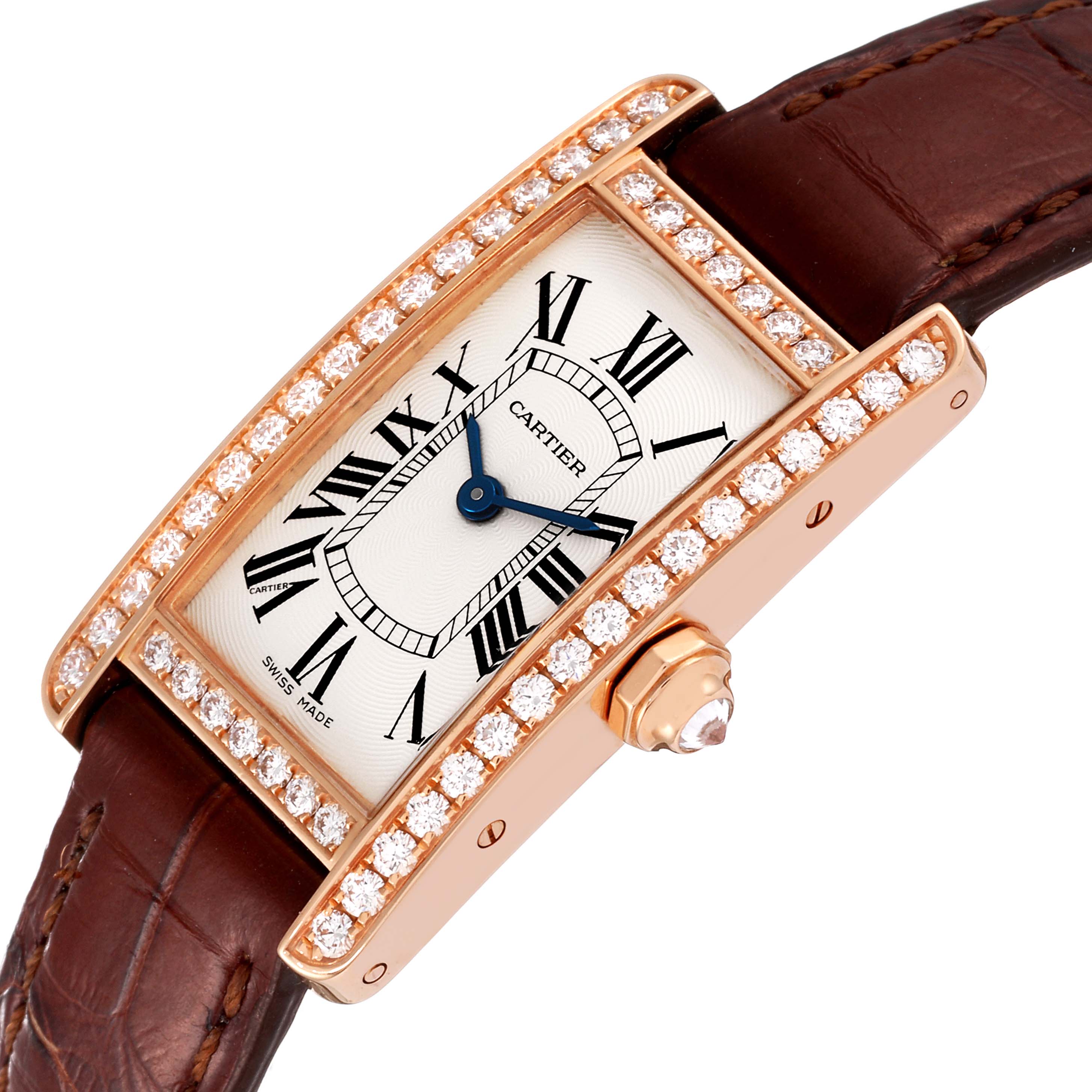 The image shows a Cartier Tank Americaine WJTA0002 Women
s Rose Gold Silver Dial WJTA0002 Women
s Rose Gold Silver Dial watch at an oblique angle, highlighting its rectangular diamond-encrusted bezel and brown leather strap.