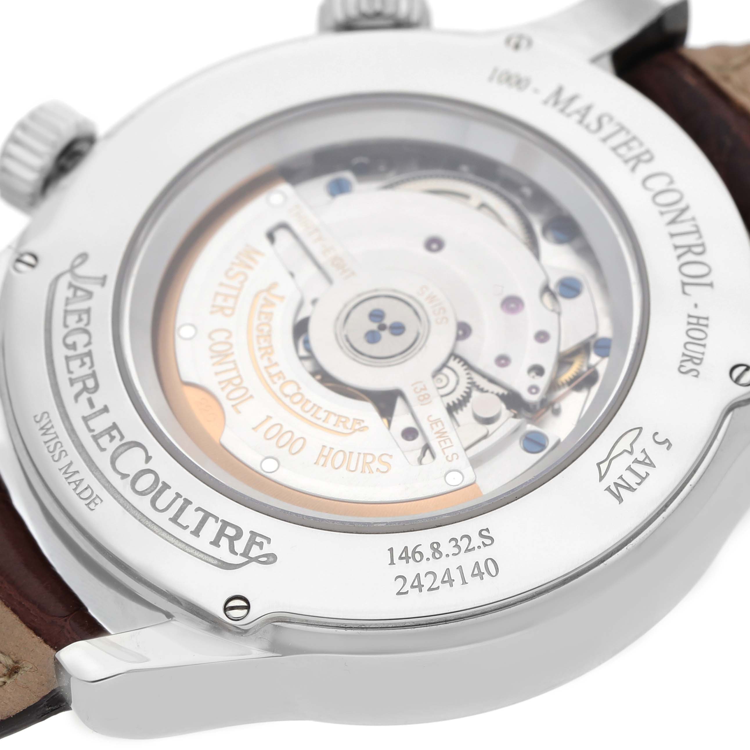The image shows the case back of a Jaeger-LeCoultre Master model, displaying its mechanical movement and engravings.