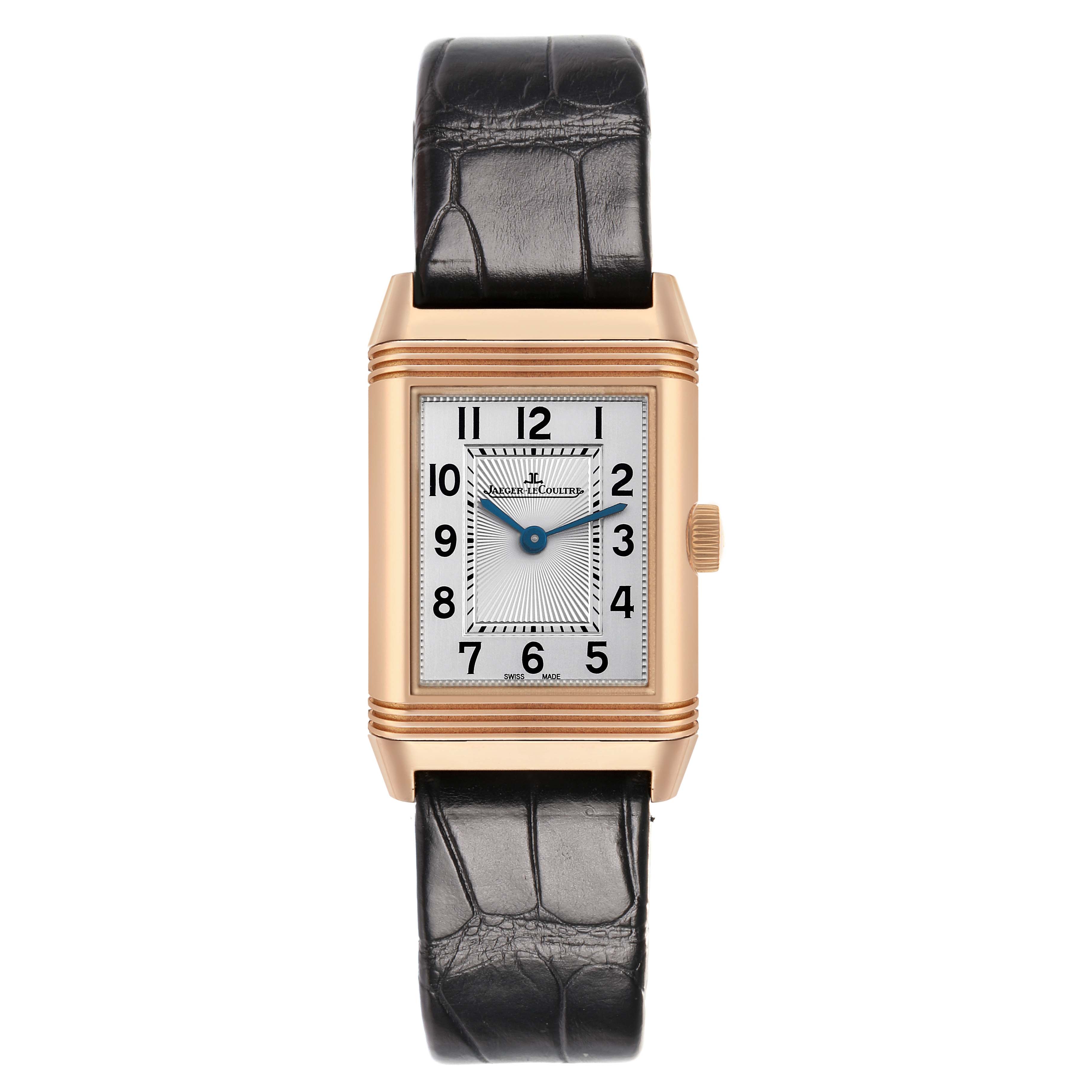 The Jaeger-LeCoultre Reverso watch is shown from a front view, highlighting its rectangular face, leather strap, and crown on the side.