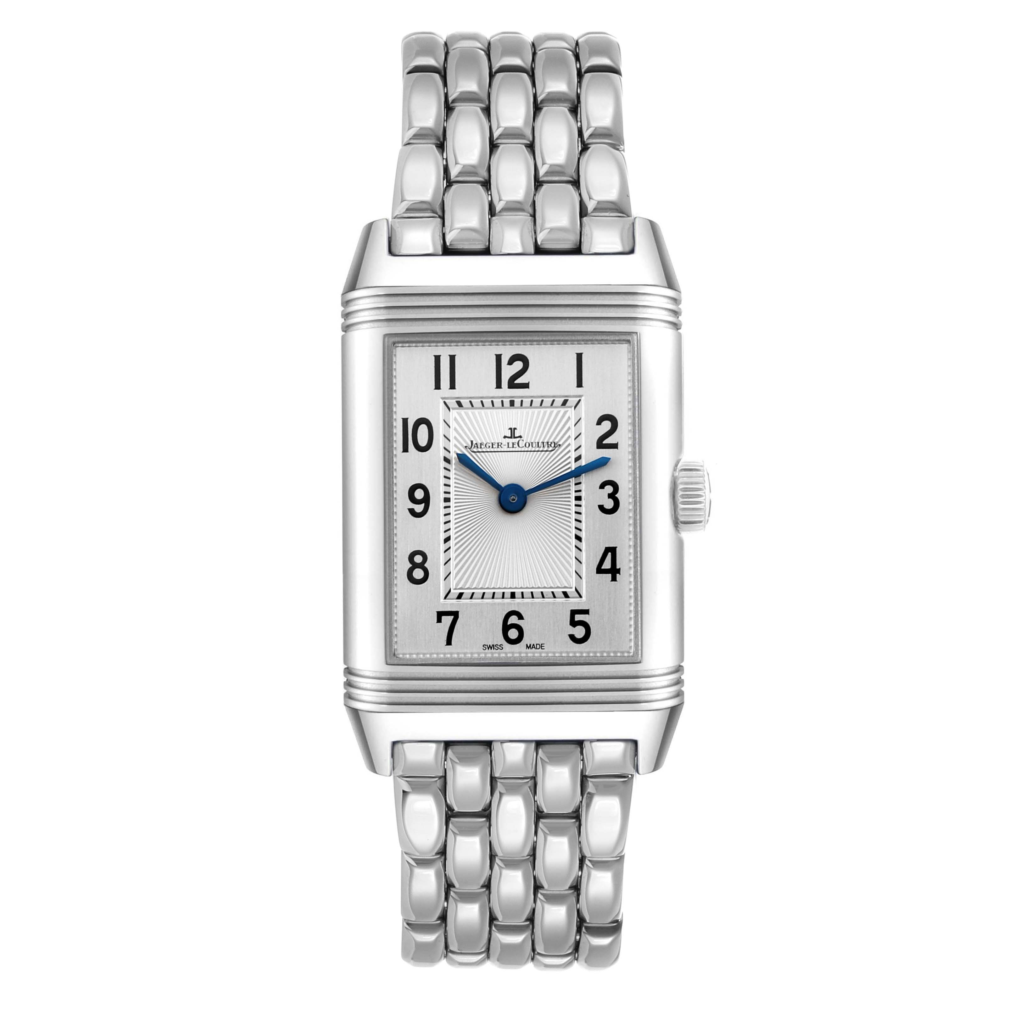 The Jaeger-LeCoultre Reverso watch is shown from a front angle, highlighting its rectangular case and linked metal bracelet.