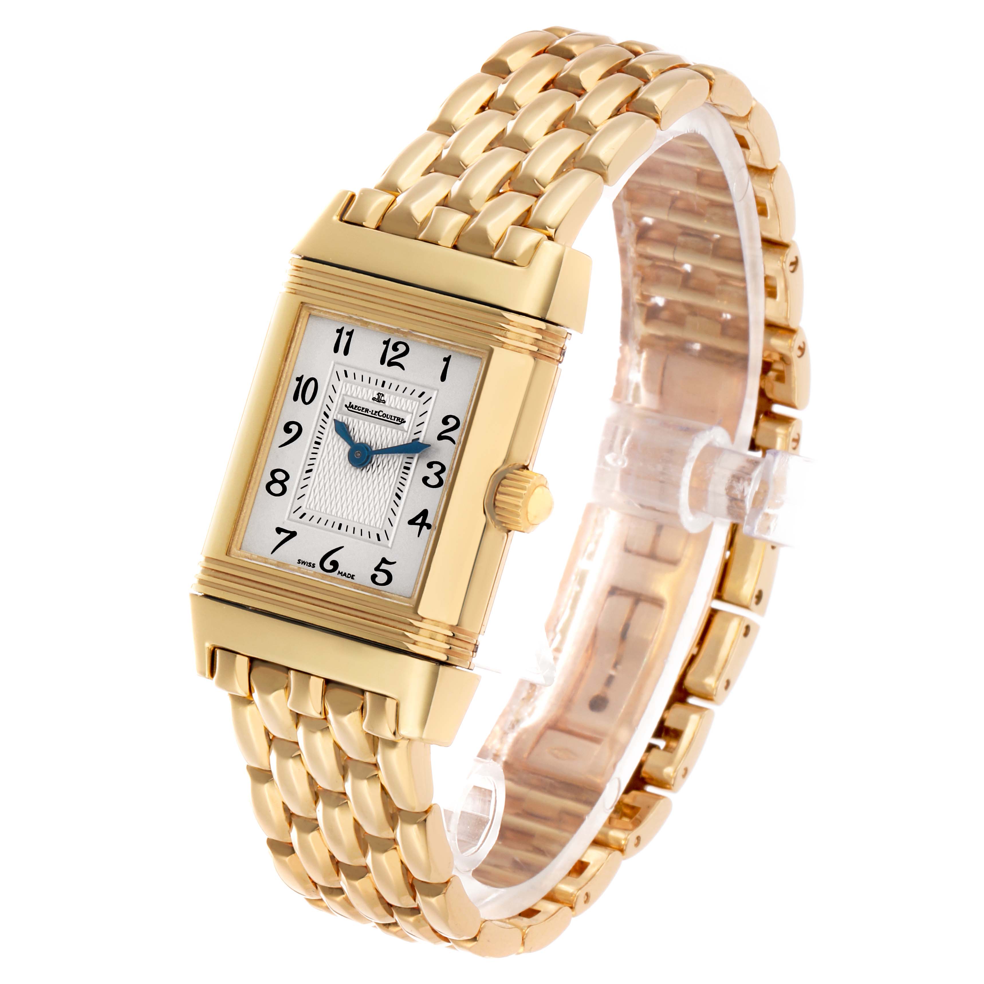 The Jaeger-LeCoultre Reverso watch is shown at an angle highlighting the gold case, white dial, and gold link bracelet.