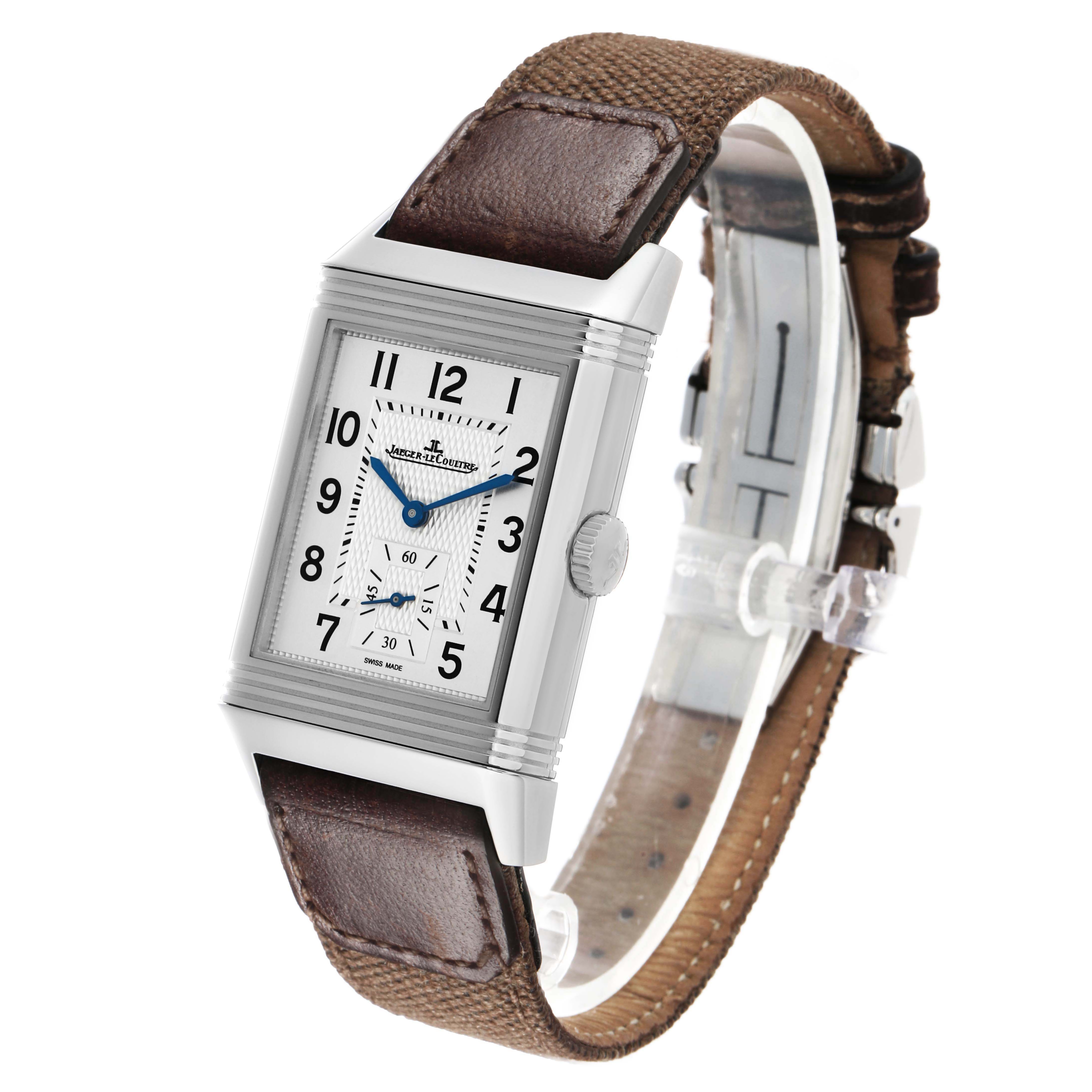 The Jaeger-LeCoultre Reverso watch is shown at an angled view, displaying its rectangular face, crown, and leather strap.