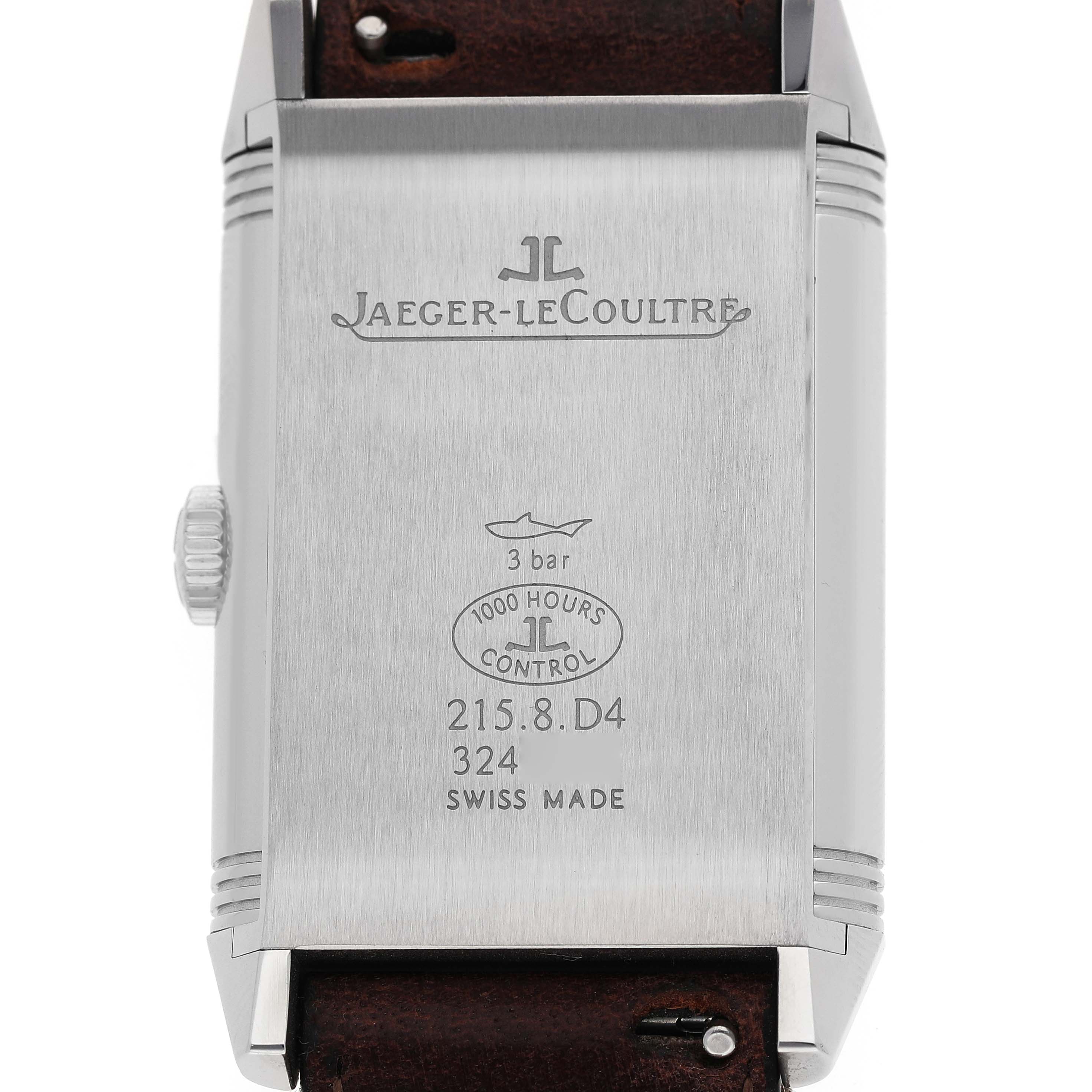 The image shows the back of the Jaeger-LeCoultre Reverso watch, highlighting its inscriptions and the crown on the side.