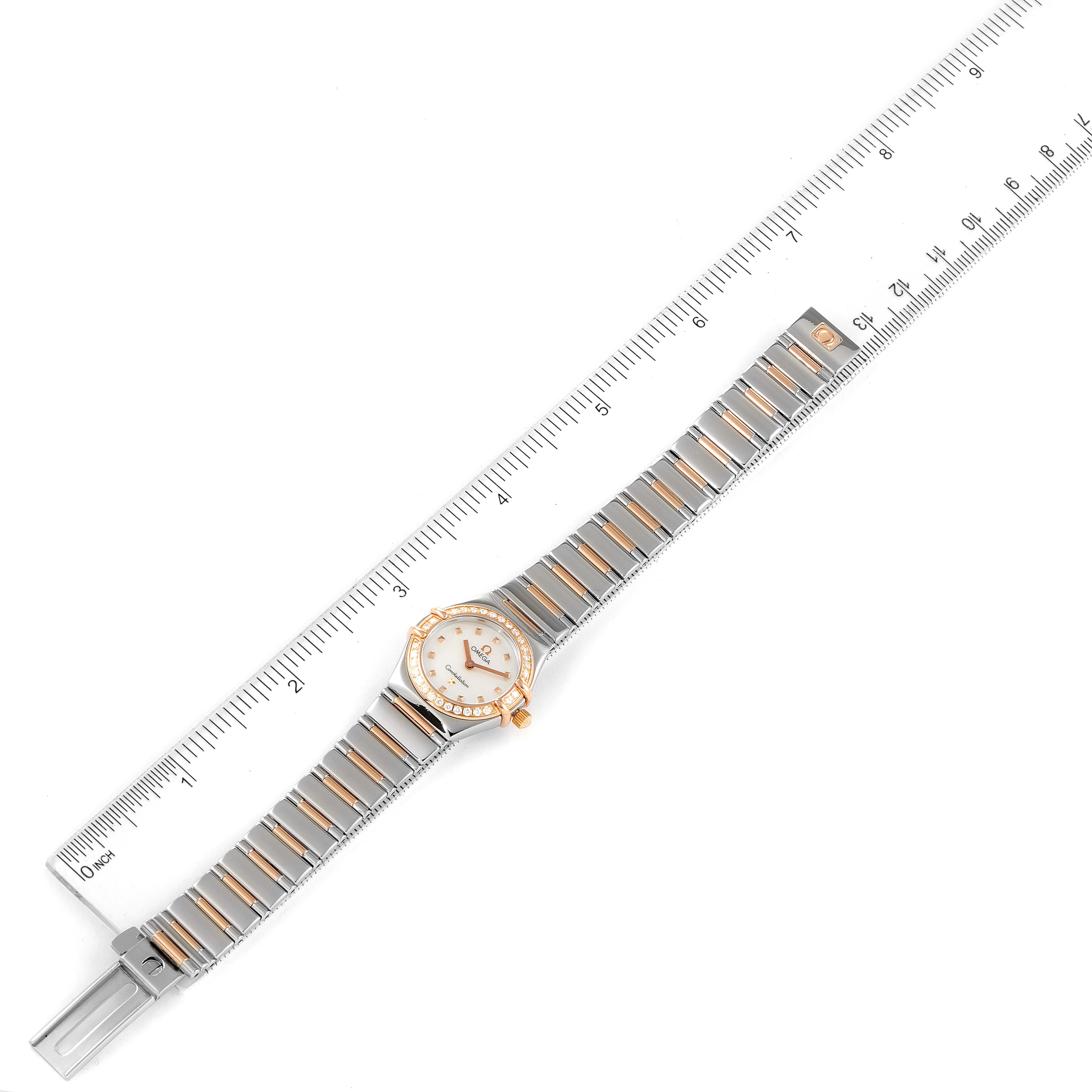 The image shows the Omega 1368.71.00 Women's Steel and Gold (two tone) Mother of Pearl Dial 1368.71.00 Women's Steel and Gold (two tone) Mother of Pearl Dial Constellation My Choice Steel Rose Gold Diamond Watch 1368.71.00 model laid flat next to a ruler.