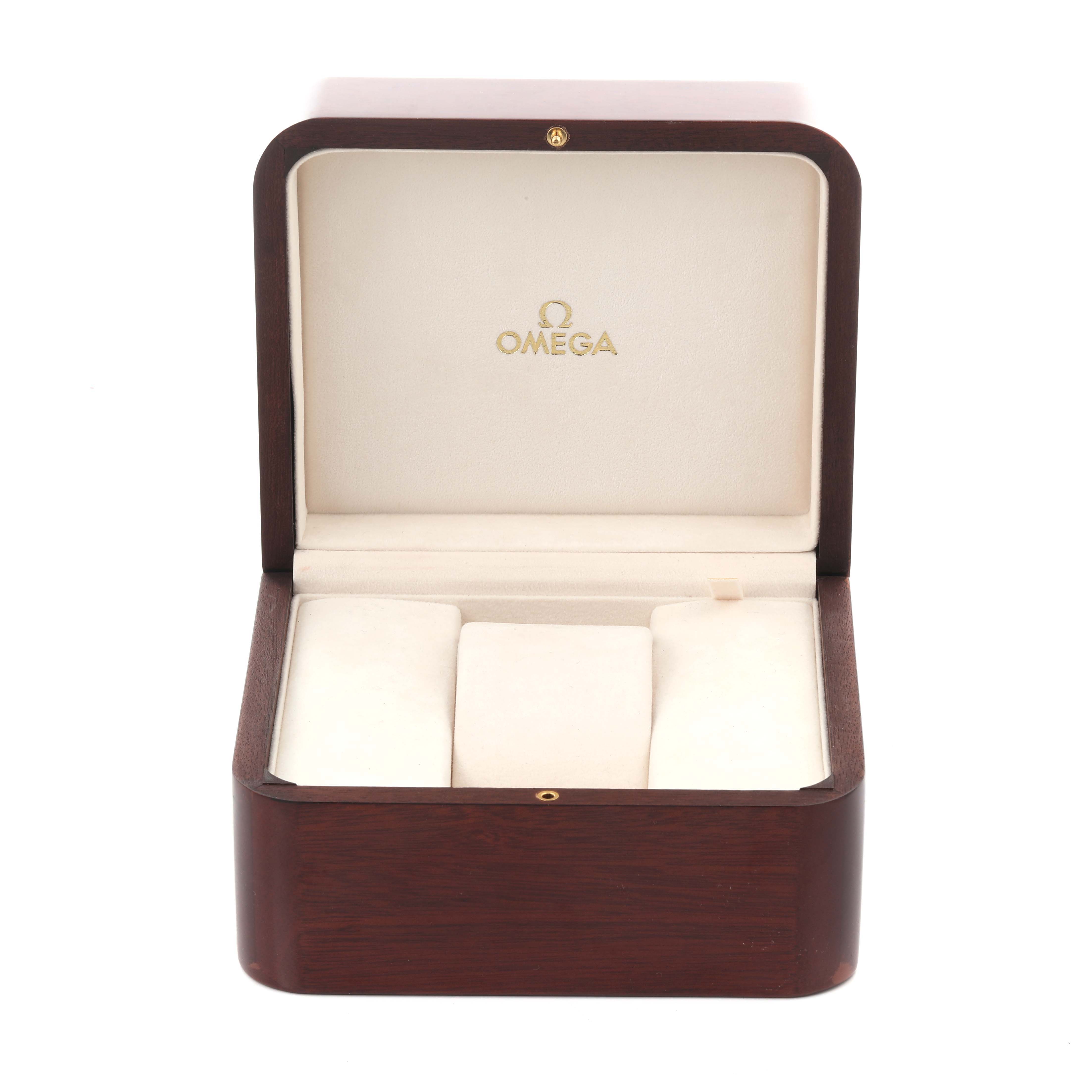 The image shows a wooden Omega Speedmaster 321.90.42.50.13.001 Men's Steel and Gold (two tone) Brown Dial 321.90.42.50.13.001 Men's Steel and Gold (two tone) Brown Dial watch box open, revealing the interior padding and Omega logo.