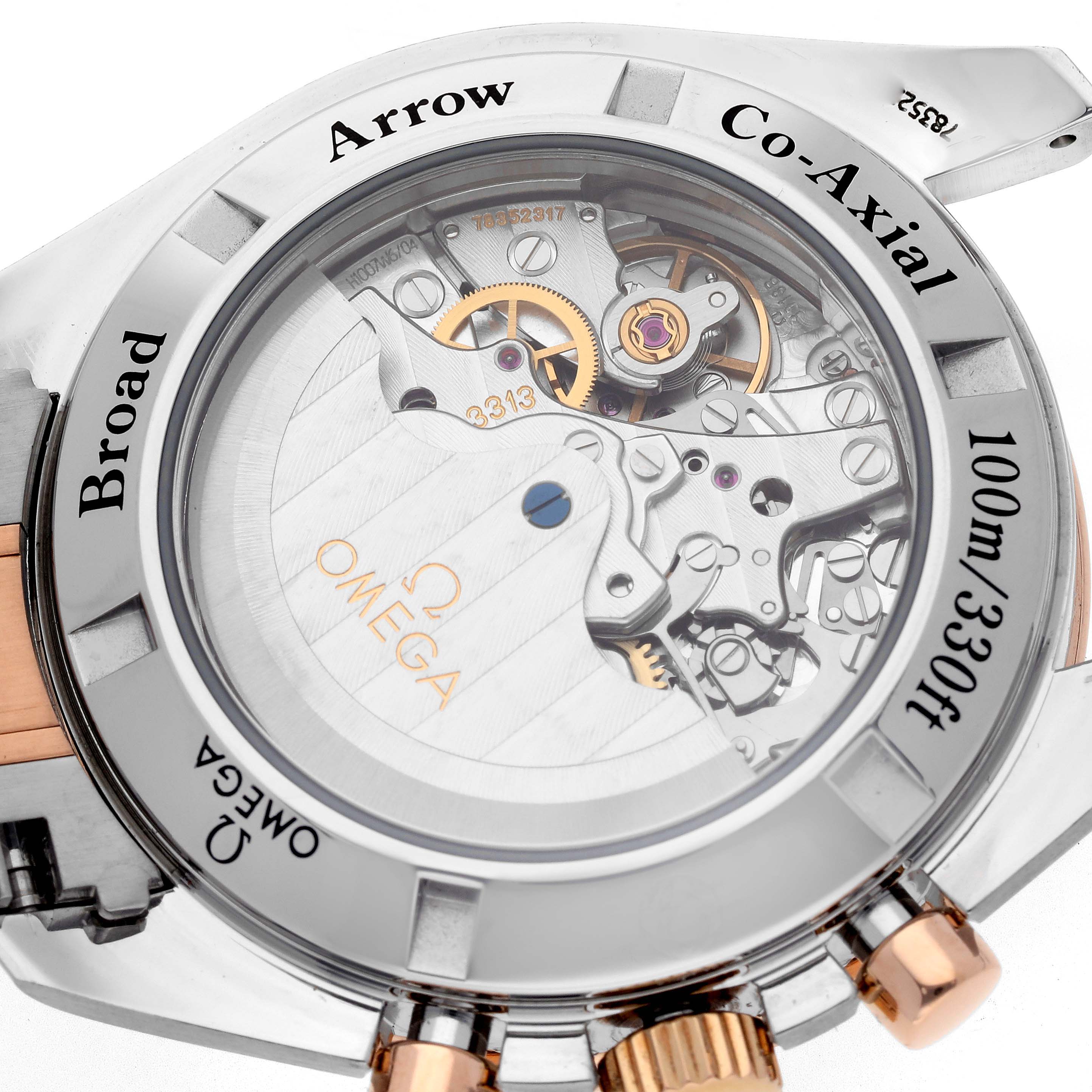 The image shows the back view of the Omega Speedmaster 321.90.42.50.13.001 Men's Steel and Gold (two tone) Brown Dial 321.90.42.50.13.001 Men's Steel and Gold (two tone) Brown Dial, highlighting its Co-Axial movement and intricate mechanisms.