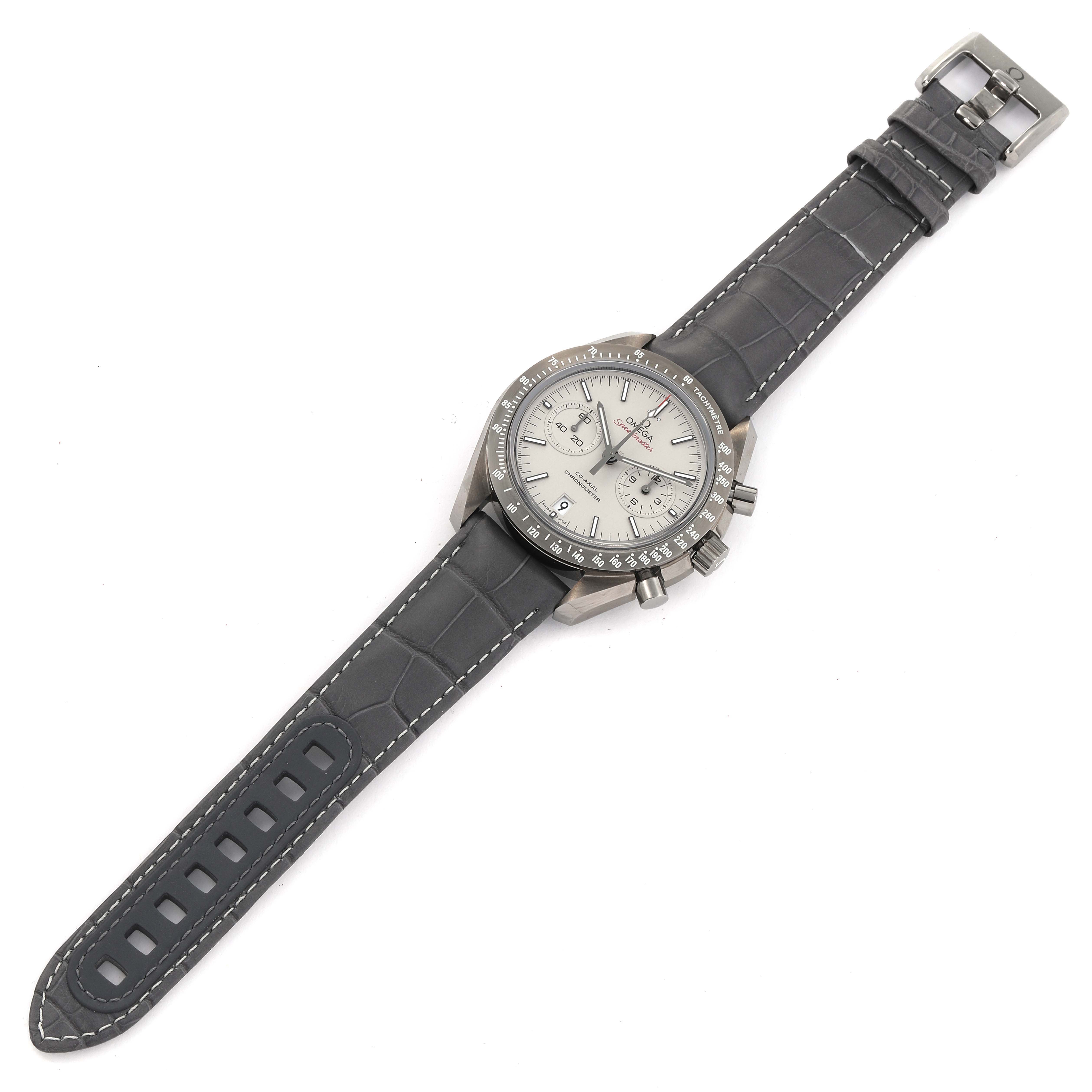 The Omega Speedmaster 311.93.44.51.99.001 Men's Ceramic Silver Dial 311.93.44.51.99.001 Men's Ceramic Silver Dial watch is shown from a top-down angle, displaying its dial, bezel, strap, and buckle.