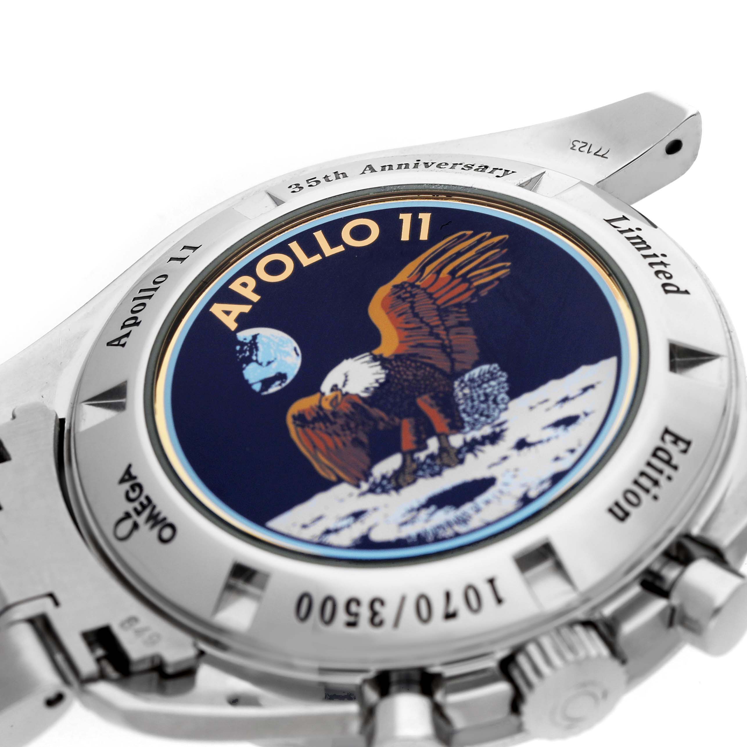 The image shows the back of the Omega Speedmaster 3569.31.00 Men's Stainless Steel Silver Dial watch, featuring the Apollo 11 35th Anniversary emblem.