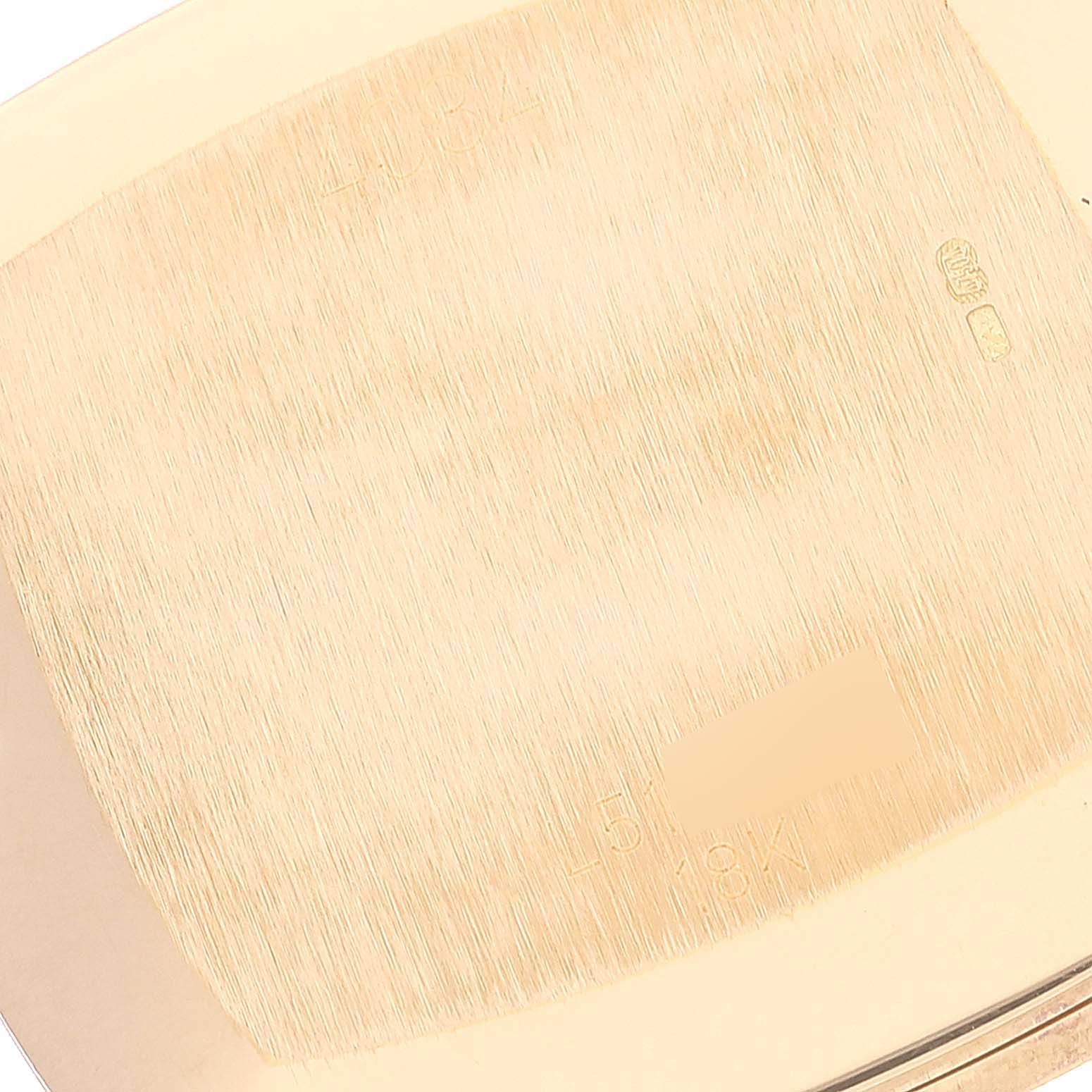 This image shows the brushed gold back case of a Rolex Cellini 4084 Men's Yellow Gold Champagne Dial 4084 Men's Yellow Gold Champagne Dial watch taken from a close-up angle.