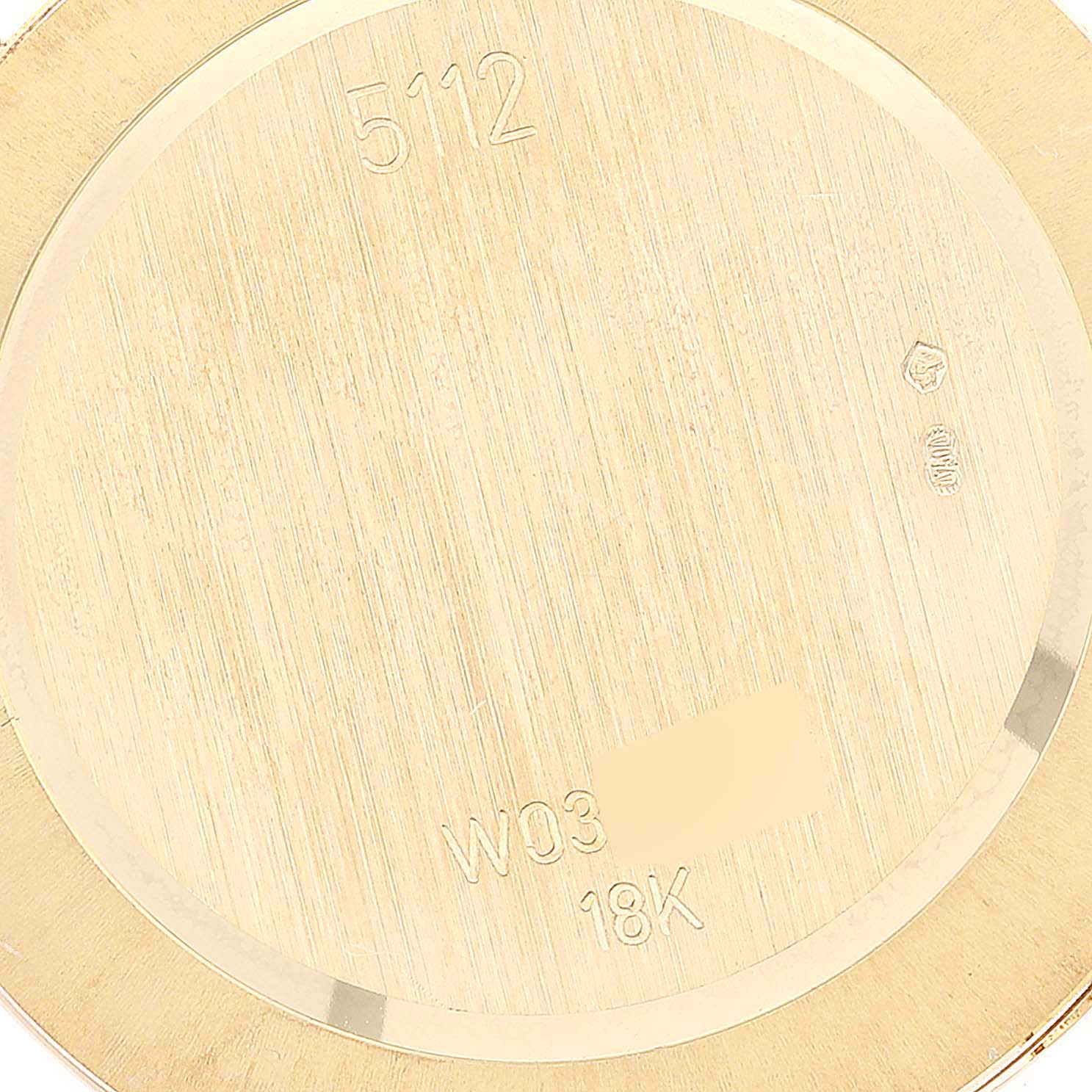 This is a close-up of the back case of a Rolex Cellini 5112 Men
s Yellow Gold Silver Dial 5112 Men
s Yellow Gold Silver Dial model, showing engravings including "5112" and "18K."