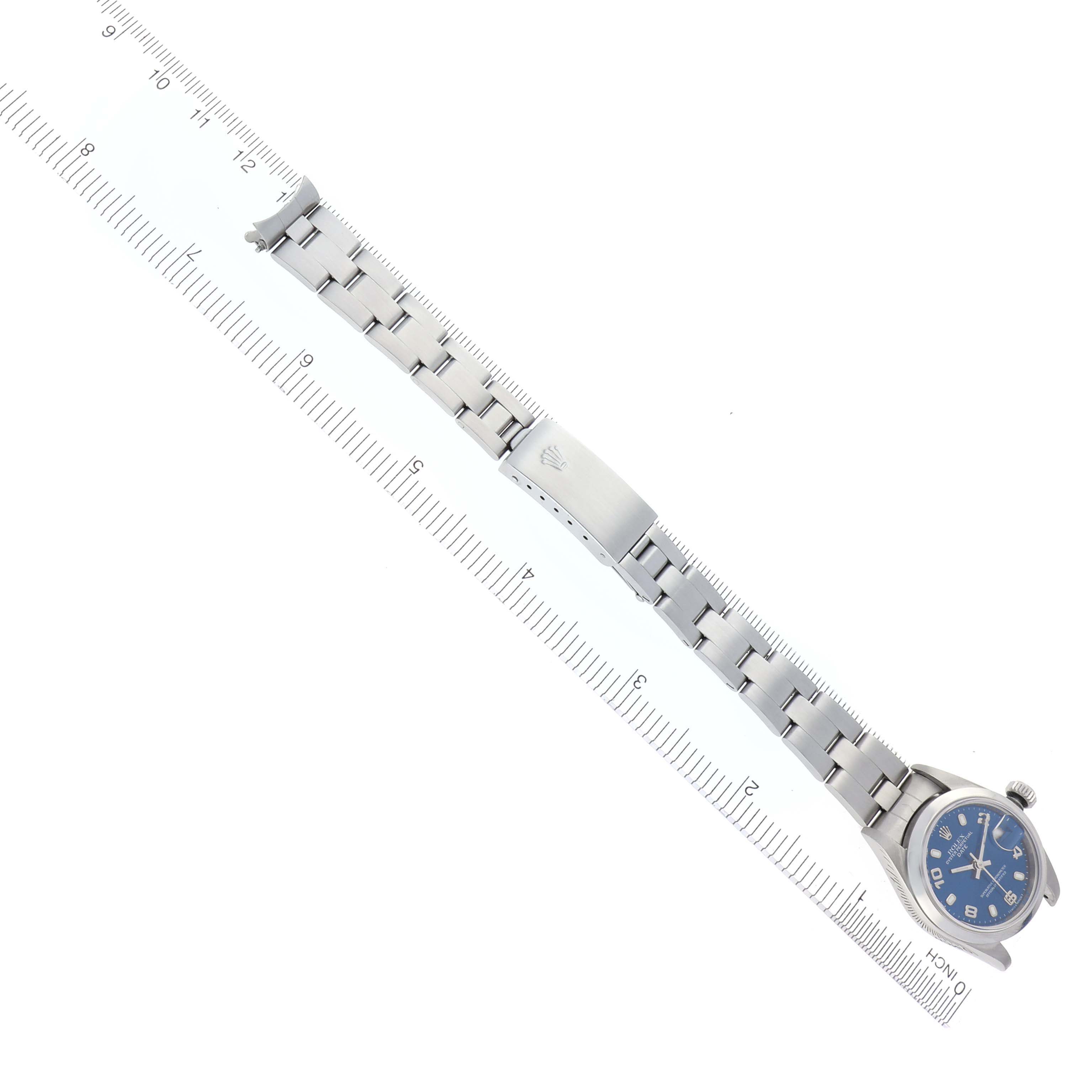 The image shows a top-down view of a Rolex Date 79160 Women
s Stainless Steel Blue Dial 79160 Women
s Stainless Steel Blue Dial watch and its bracelet, aligned with a ruler.