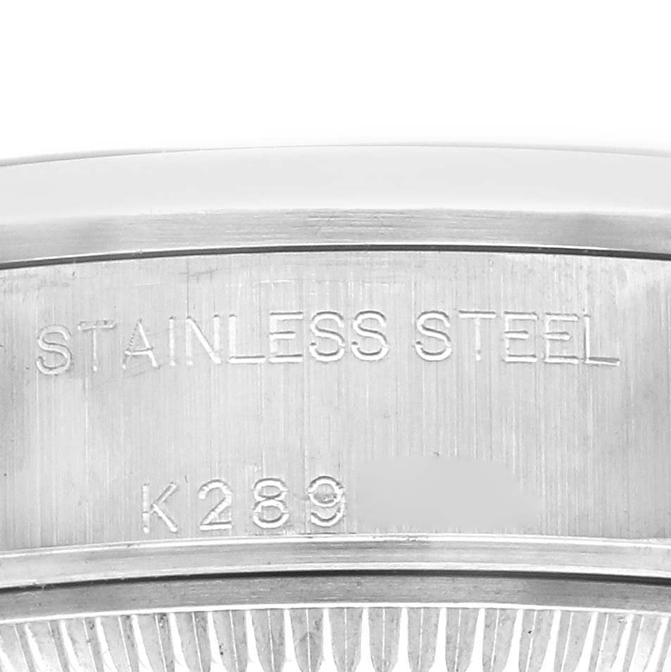 The image shows a close-up of the watch case side of a Rolex Date 79160 Women
s Stainless Steel Blue Dial 79160 Women
s Stainless Steel Blue Dial model, displaying the "STAINLESS STEEL" engraving.