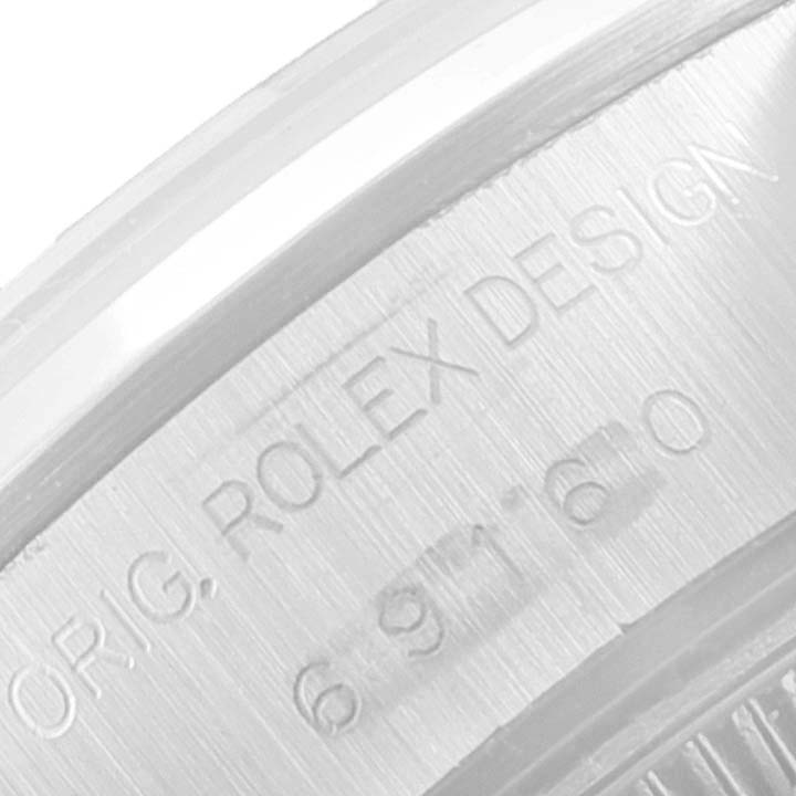 The image shows a close-up of the engravings on the side of the case for a Rolex Date 69160 Women's Stainless Steel Blue Dial 69160 Women's Stainless Steel Blue Dial model.