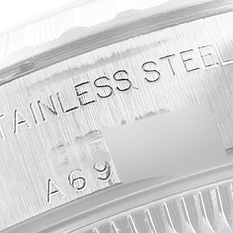 The image shows a close-up view of a stainless steel engraving inside the case of a Rolex Date 79240 Women's Stainless Steel Silver Dial 79240 Women's Stainless Steel Silver Dial watch.