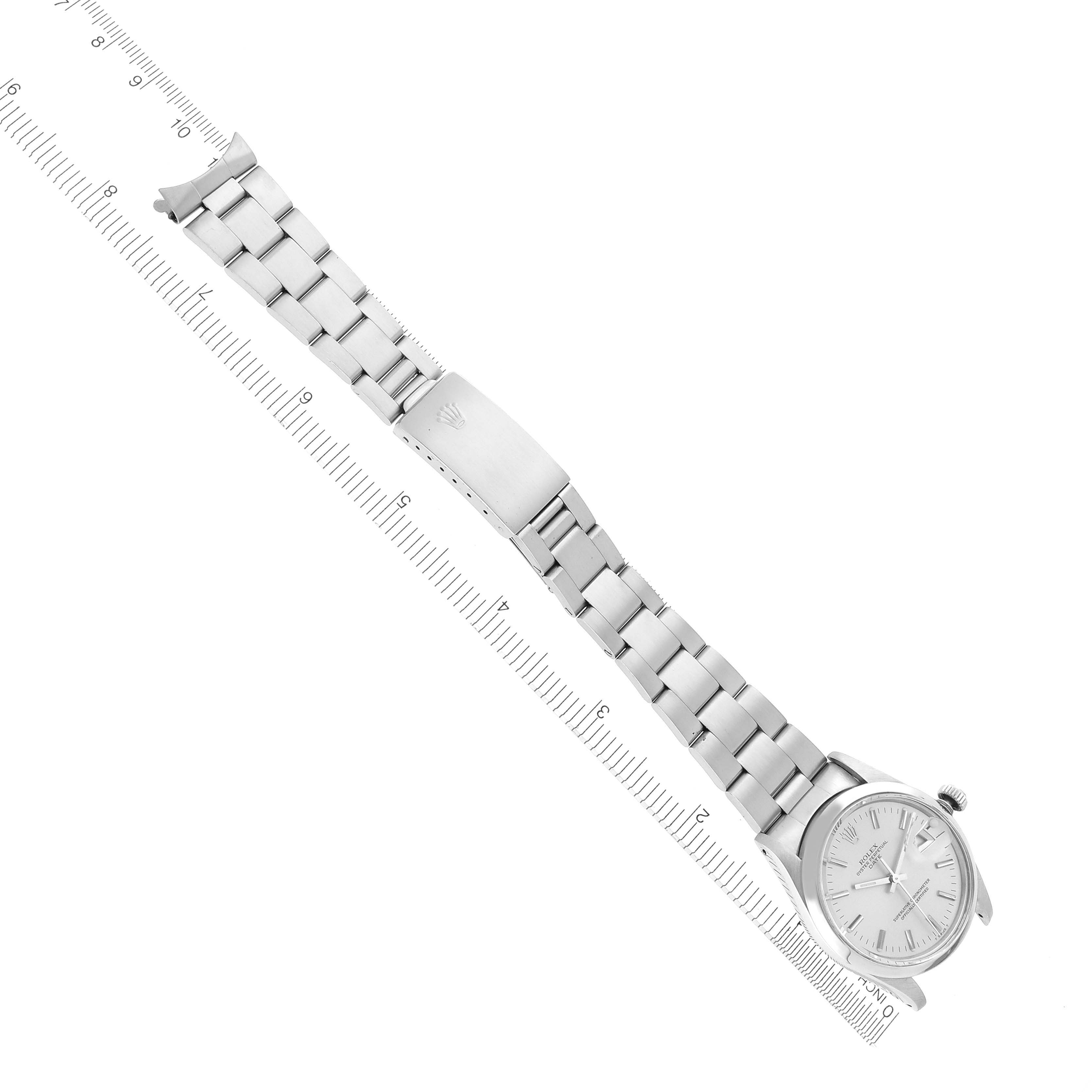 The Rolex Date 15000 Men's Stainless Steel Silver Dial 15000 Men's Stainless Steel Silver Dial watch is shown from a top-down angle, displaying its full metal bracelet and clasp.