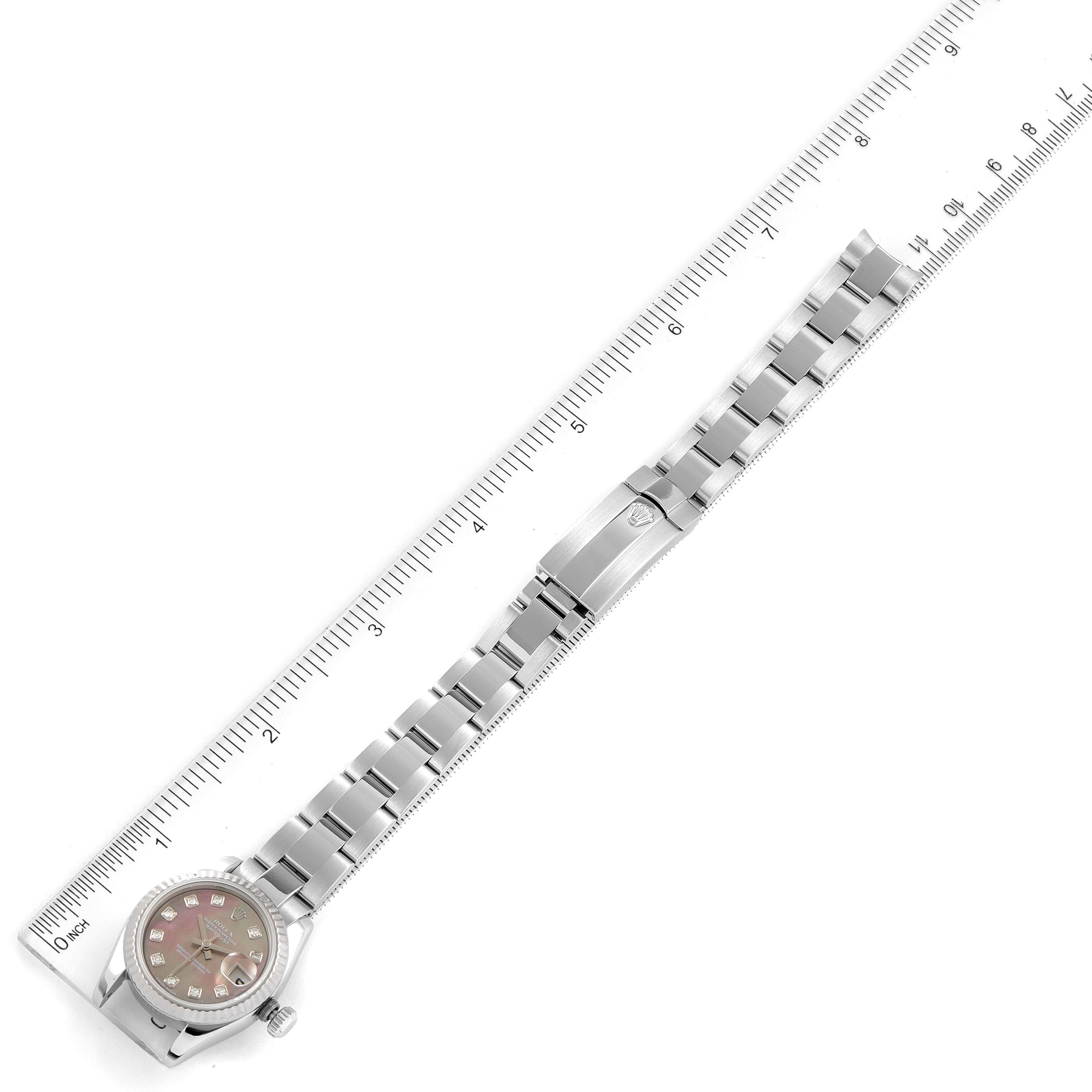 The image shows a Rolex Datejust 179174 Women's Stainless Steel Mother of Pearl Dial 179174 Women's Stainless Steel Mother of Pearl Dial watch laid flat with a ruler for scale, displaying the face, bracelet, and clasp.