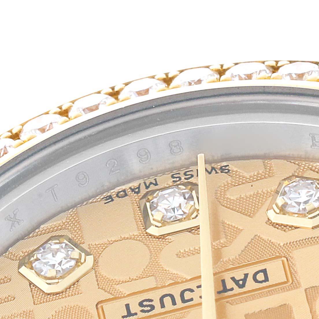 The close-up image of a Rolex Datejust 179383 Women's Steel and Gold (two tone) Champagne Dial 179383 Women's Steel and Gold (two tone) Champagne Dial watch shows part of its dial, gold text, and gem-encrusted bezel.