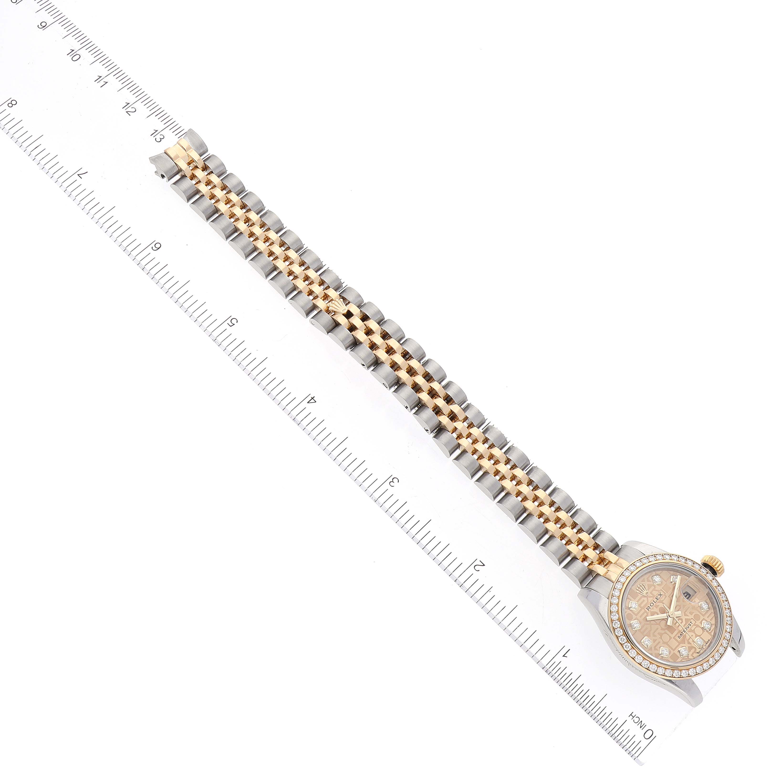 The image shows a Rolex Datejust 179383 Women's Steel and Gold (two tone) Champagne Dial 179383 Women's Steel and Gold (two tone) Champagne Dial watch from a top-down angle, displaying the face and entire band alongside a ruler.