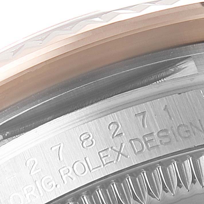 The image shows a close-up of the side of a Mid-Size Rolex watch casing, featuring an engraved serial number.