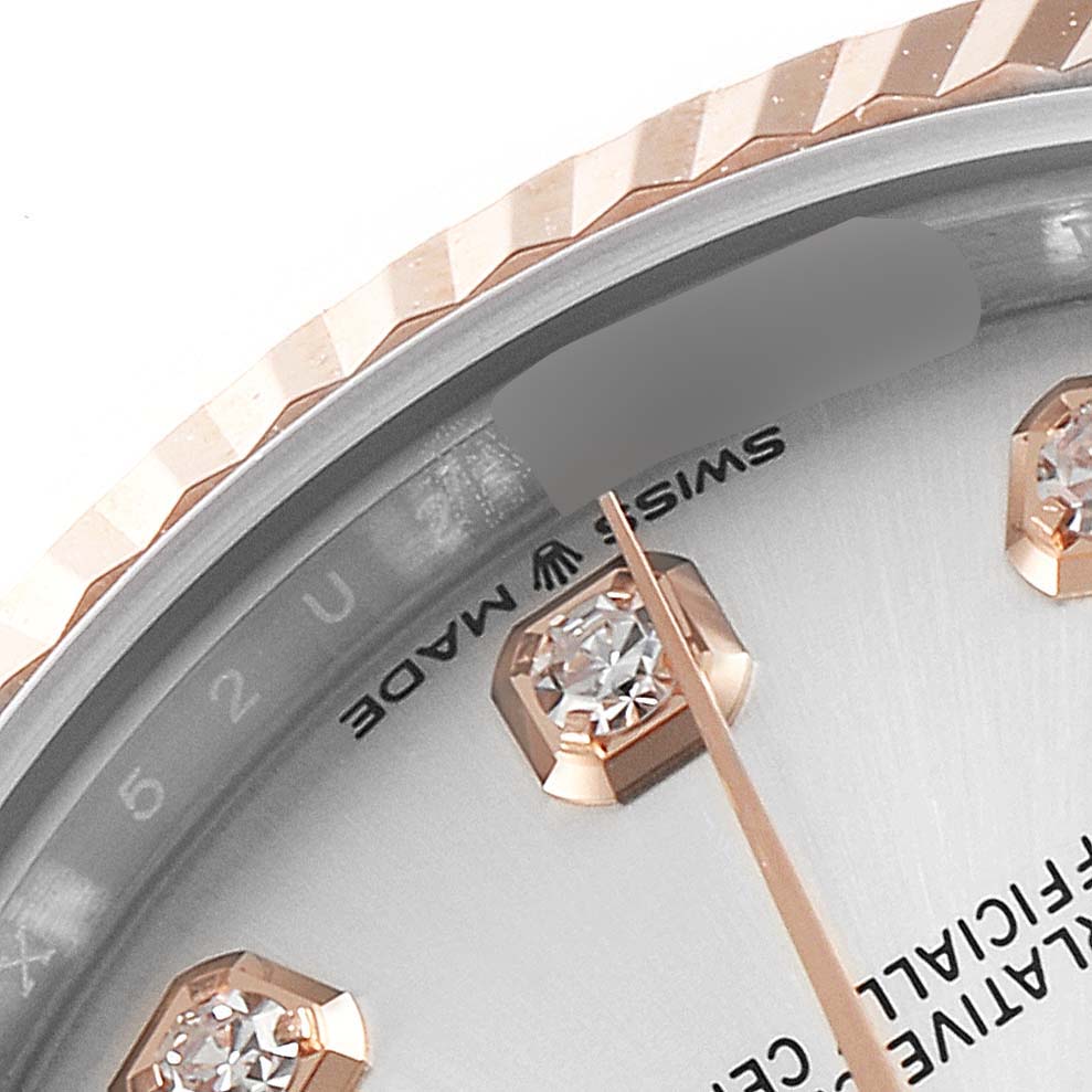 The image shows a close-up of the dial, bezel, and diamond markers of a mid-size Rolex watch.