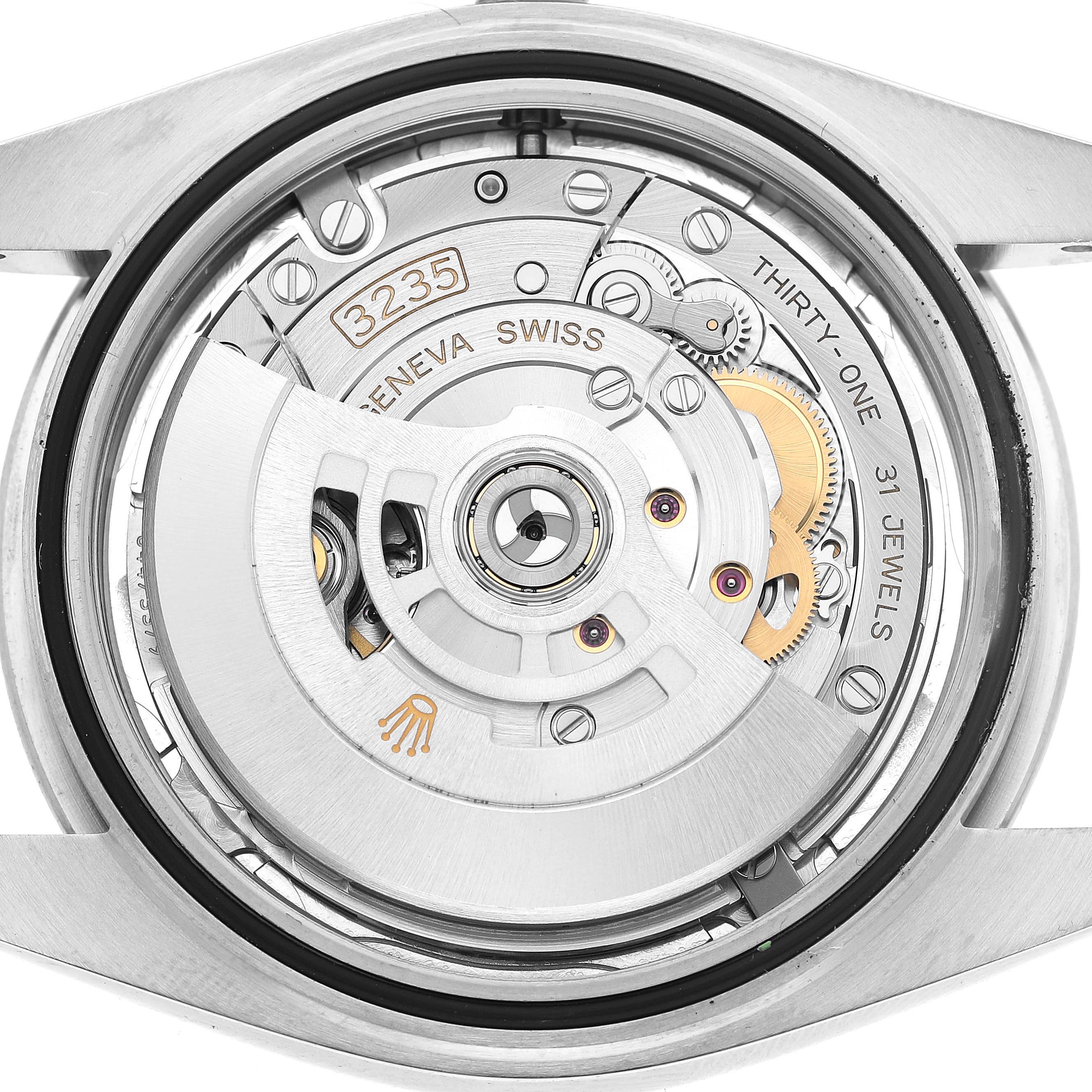 The image shows the inner mechanism of a Rolex Datejust 41 126300 Men's Stainless Steel Silver Dial watch, focusing on the movement and rotor from a top-down angle.
