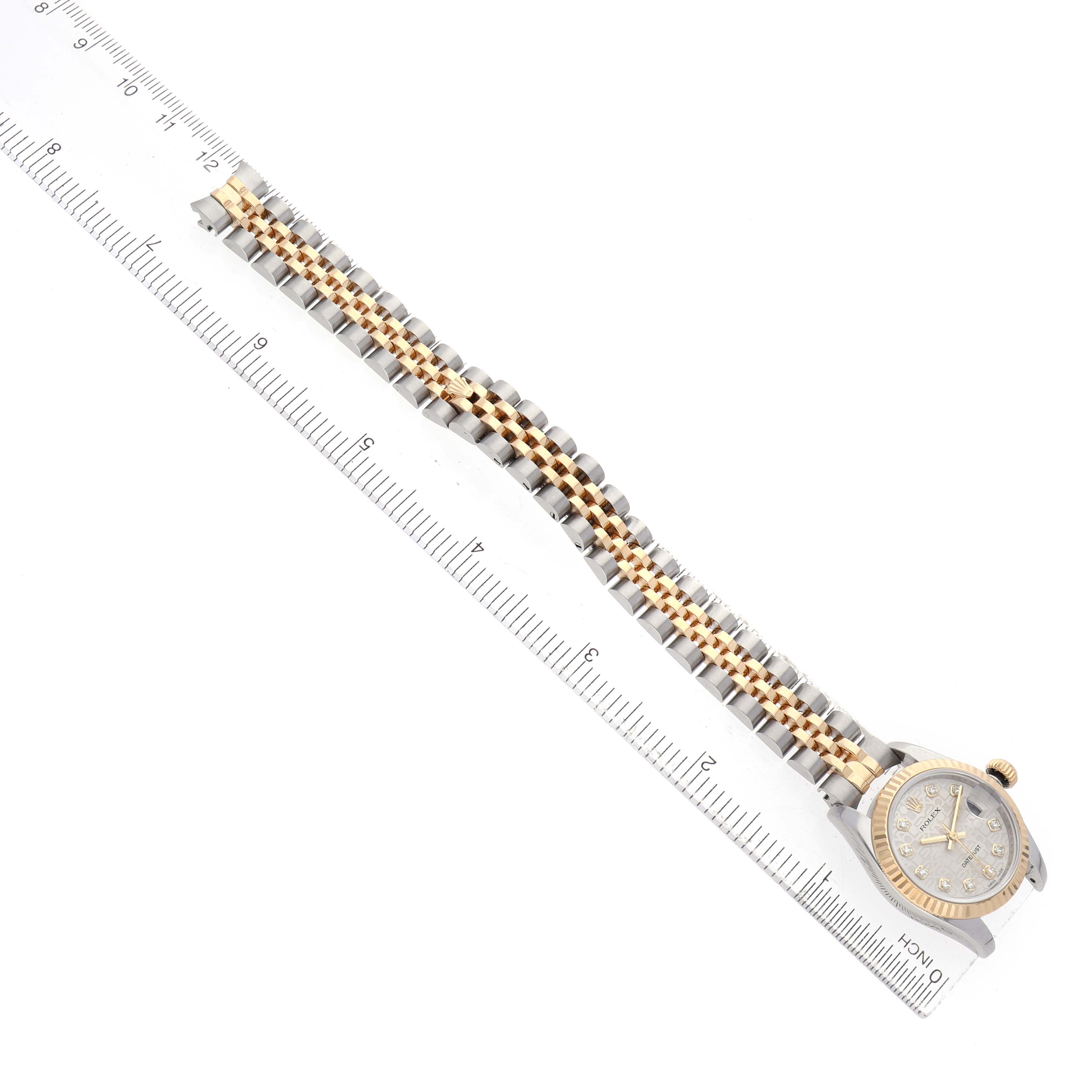 The Rolex Datejust 179173 Women's Steel and Gold (two tone) Silver Dial watch is shown from a top-down angle, highlighting its bracelet and dial.