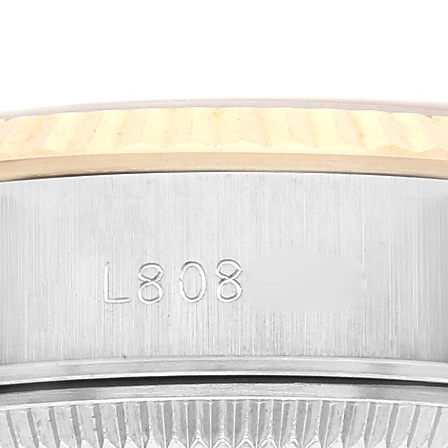 The image shows a close-up of the side of the bezel and case of a Rolex Datejust 69173 Women's Steel and Gold (two tone) Champagne Dial 69173 Women's Steel and Gold (two tone) Champagne Dial watch, highlighting engraved numbers.