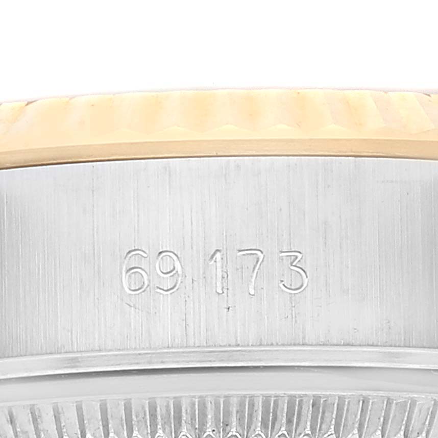 This close-up image of a Rolex Datejust 69173 Women's Steel and Gold (two tone) Champagne Dial 69173 Women's Steel and Gold (two tone) Champagne Dial watch shows the model number engraved on the side of the case.