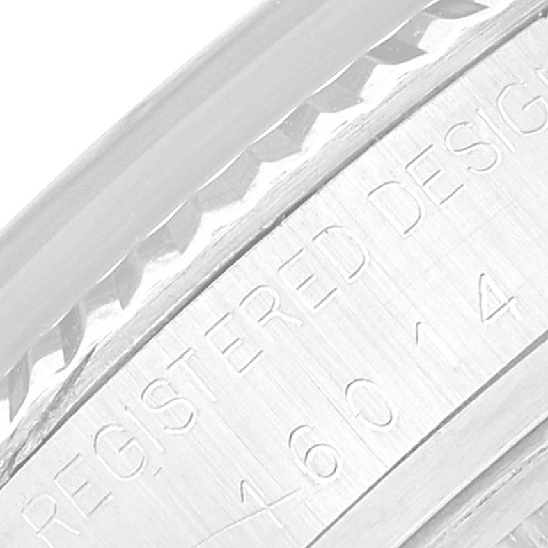 This close-up image of the Rolex Datejust 16014 Men's Stainless Steel Blue Dial 16014 Men's Stainless Steel Blue Dial watch shows the side engraving of the case and part of the bezel.