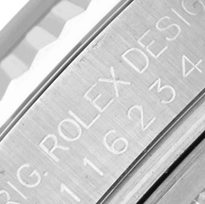 This is a close-up of the Rolex Datejust 116234 Men's Stainless Steel Silver Dial 116234 Men's Stainless Steel Silver Dial model’s case, showing engraved details and bezel edge.
