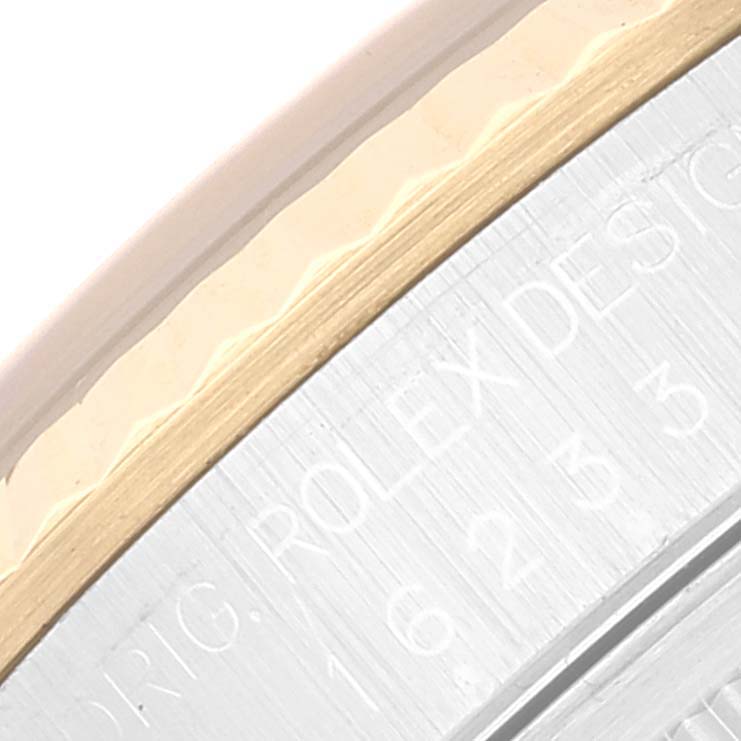 The image shows a close-up of the side of a Rolex Datejust 16233 Men's Steel and Gold (two tone) Black Dial 16233 Men's Steel and Gold (two tone) Black Dial watch, highlighting the bezel and inscription on the case.